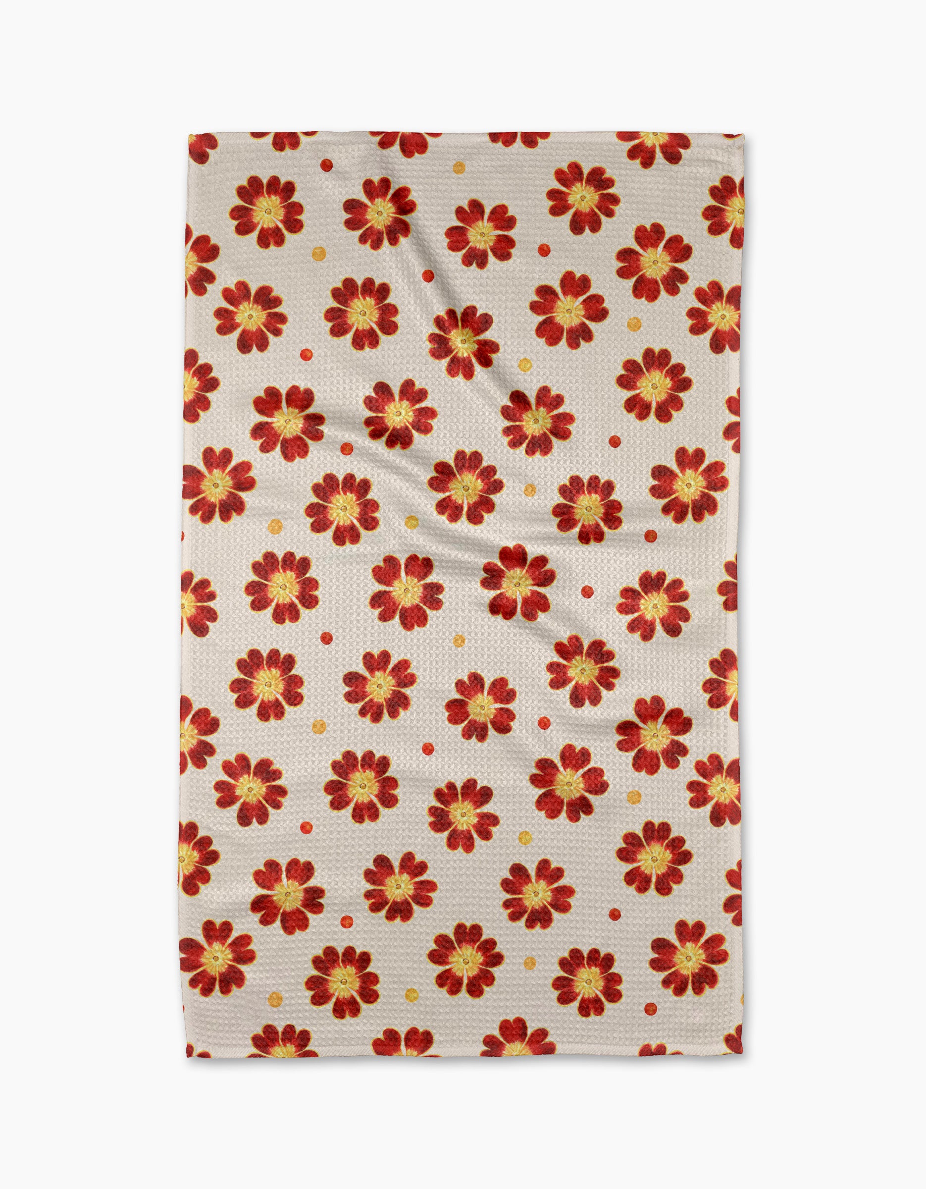 The Linda Fox Spotty Floral tea towel is beige and rectangular, with a repeating red and yellow flower pattern and small red dots. Made from quick-drying recycled materials, it’s shown laid flat with subtle wrinkles.