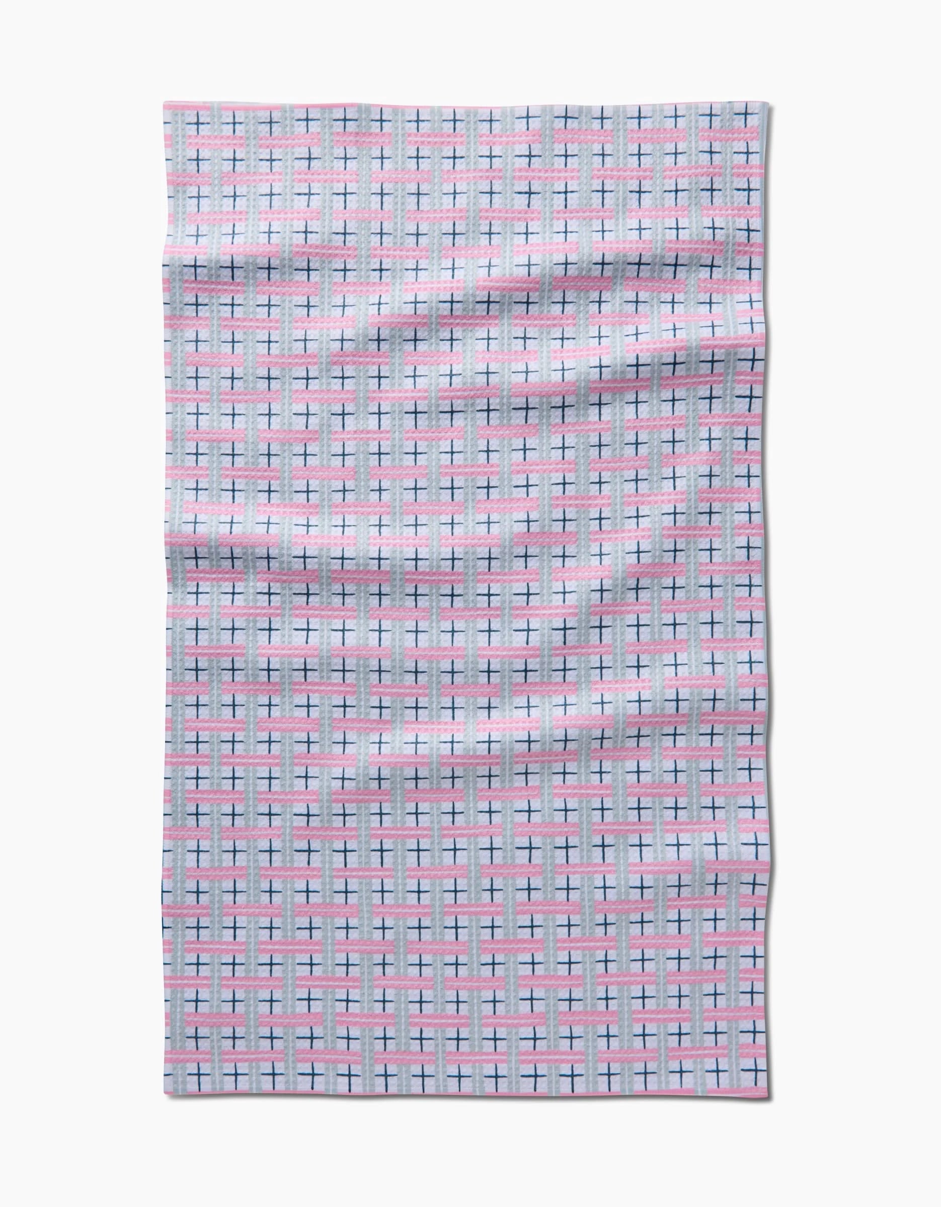 A rectangular, light-colored Hufton Studio Spring Cottage Plaid Tea Towel featuring a plaid design in pink, blue, and black lines on Geoweave fabric. The slightly wrinkled towel is shown on a white background.