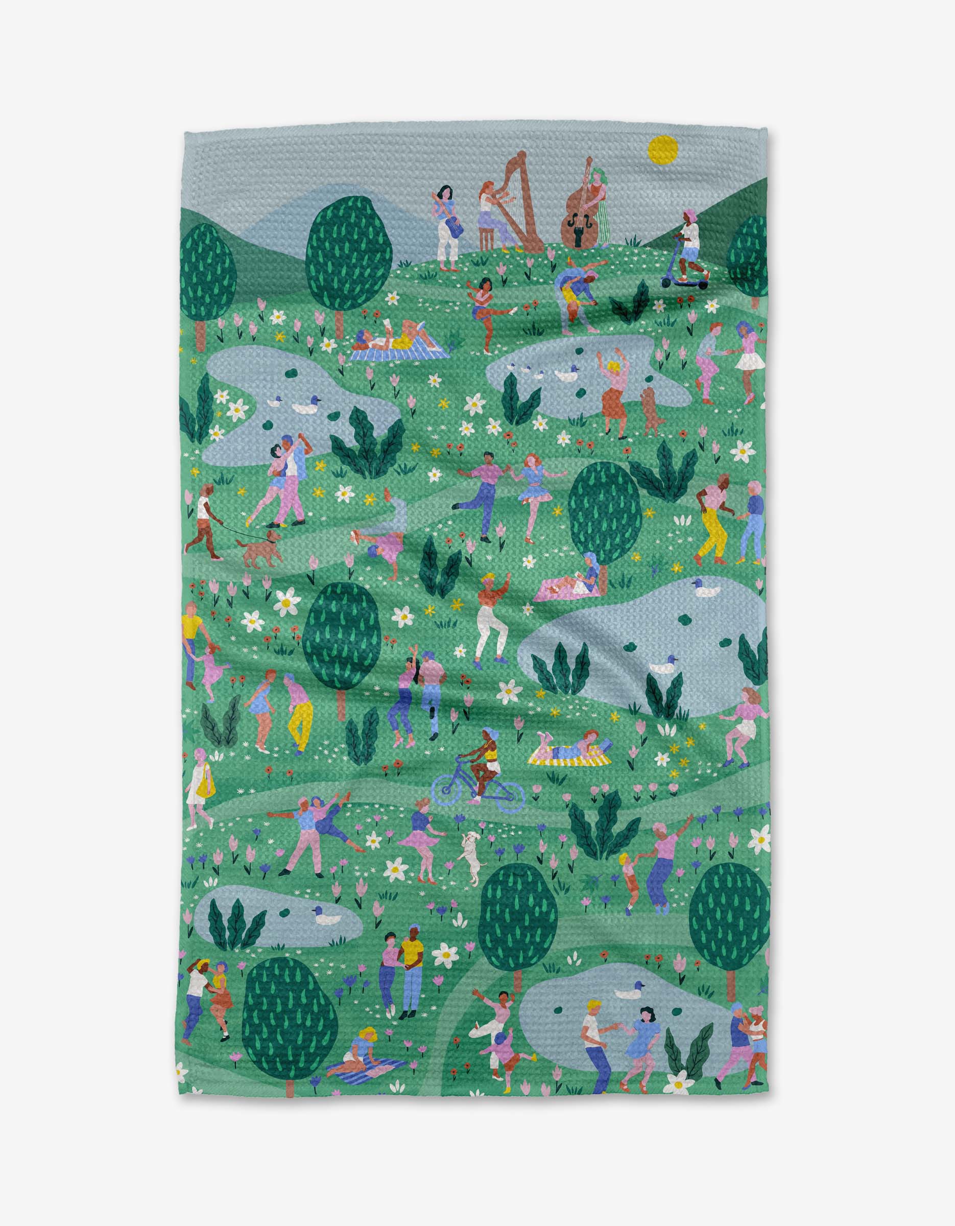 Spring Festival by Ceyda Alasar is a vibrant Geoweave fabric blanket depicting people dancing, making music, and relaxing in a sunny park with trees, flowers, and rolling hills.