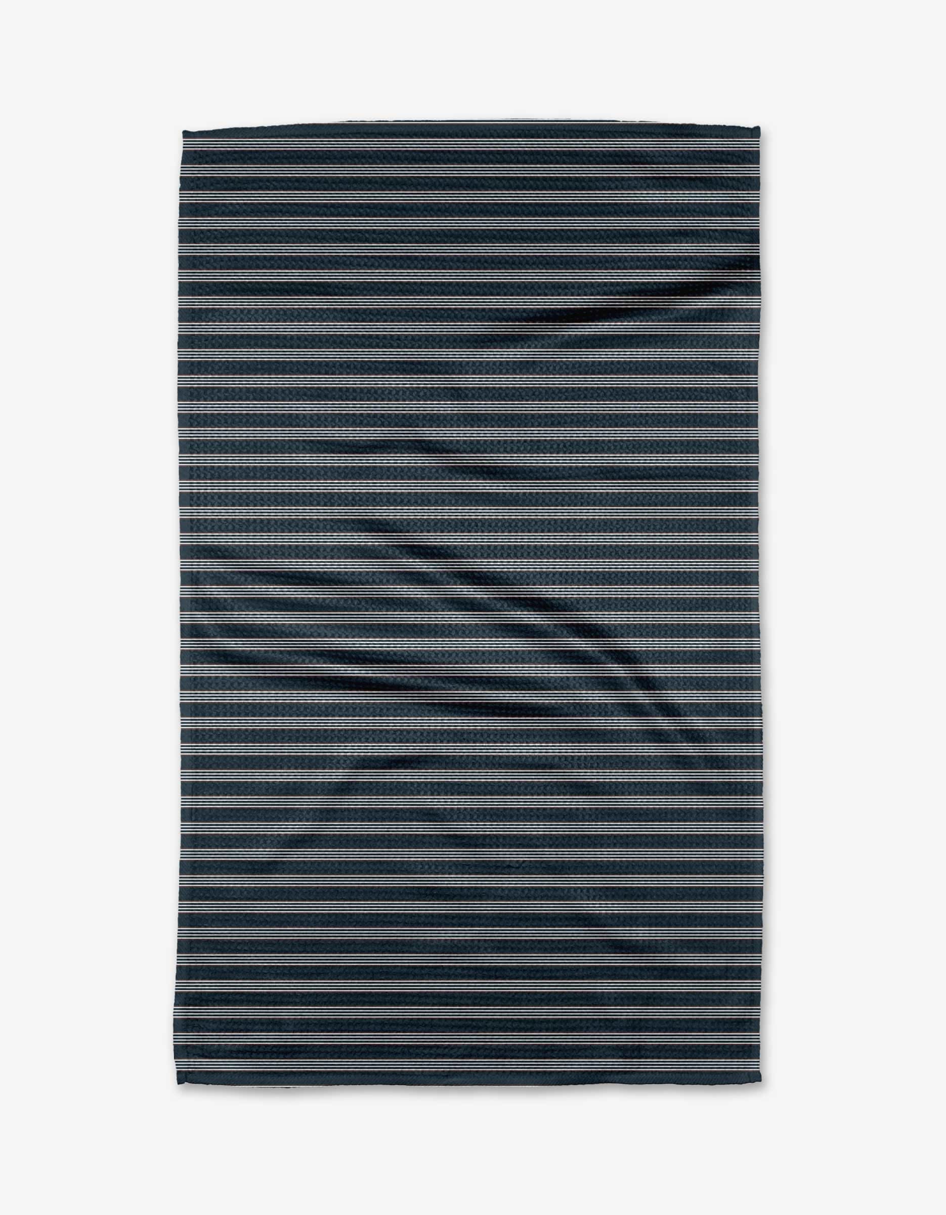 The Buy Guide Straight Across - Navy Tea Towel features thin, evenly spaced horizontal black and gray stripes on ultra-absorbent Geoweave™ fabric, shown flat with slight wrinkles against a white background.