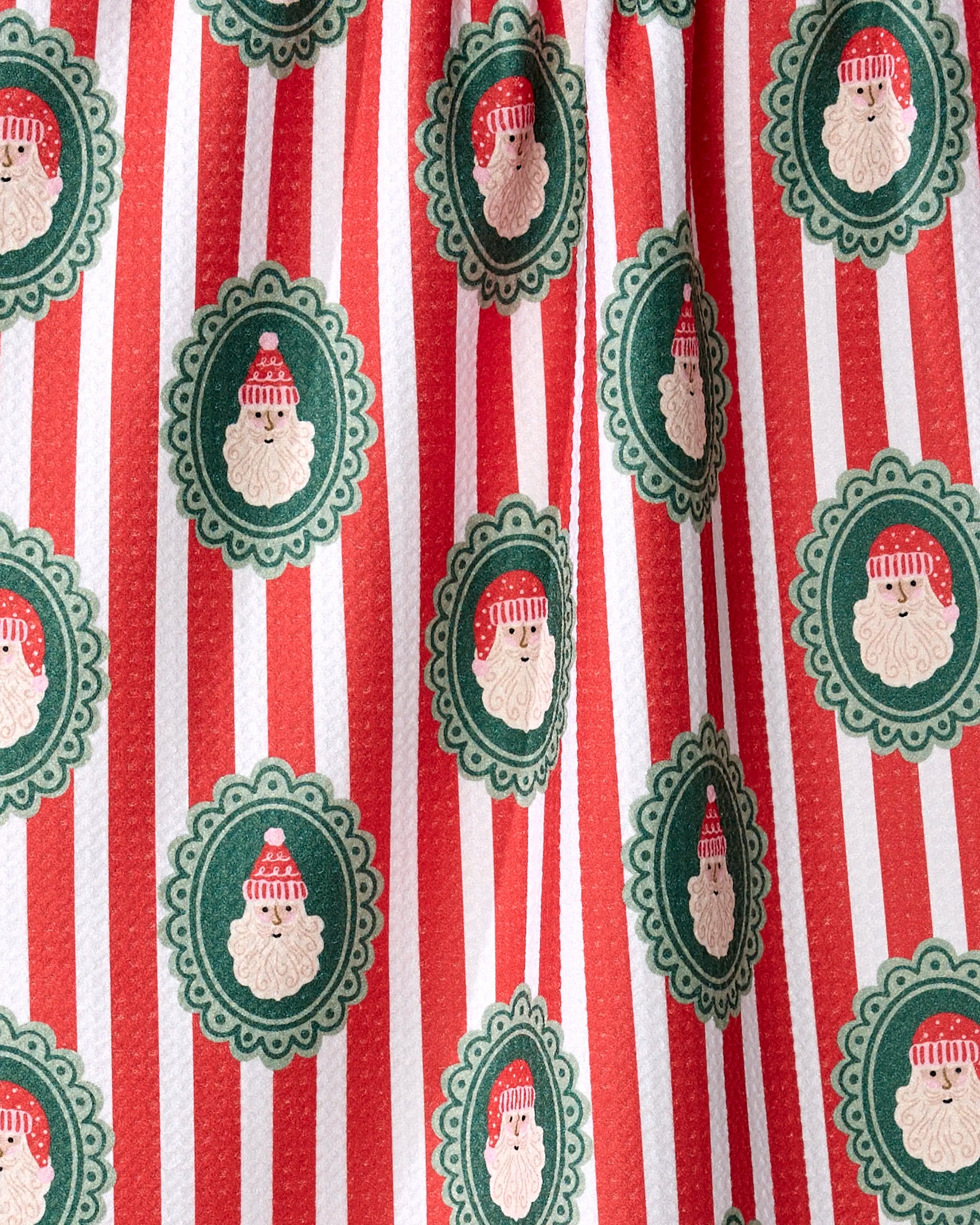Charlie Rowan Designs’ Striped Santa tea towel features red and white stripes with green oval Santa faces in a festive pattern, made from ultra-absorbent recycled materials—perfect for your holiday kitchen.