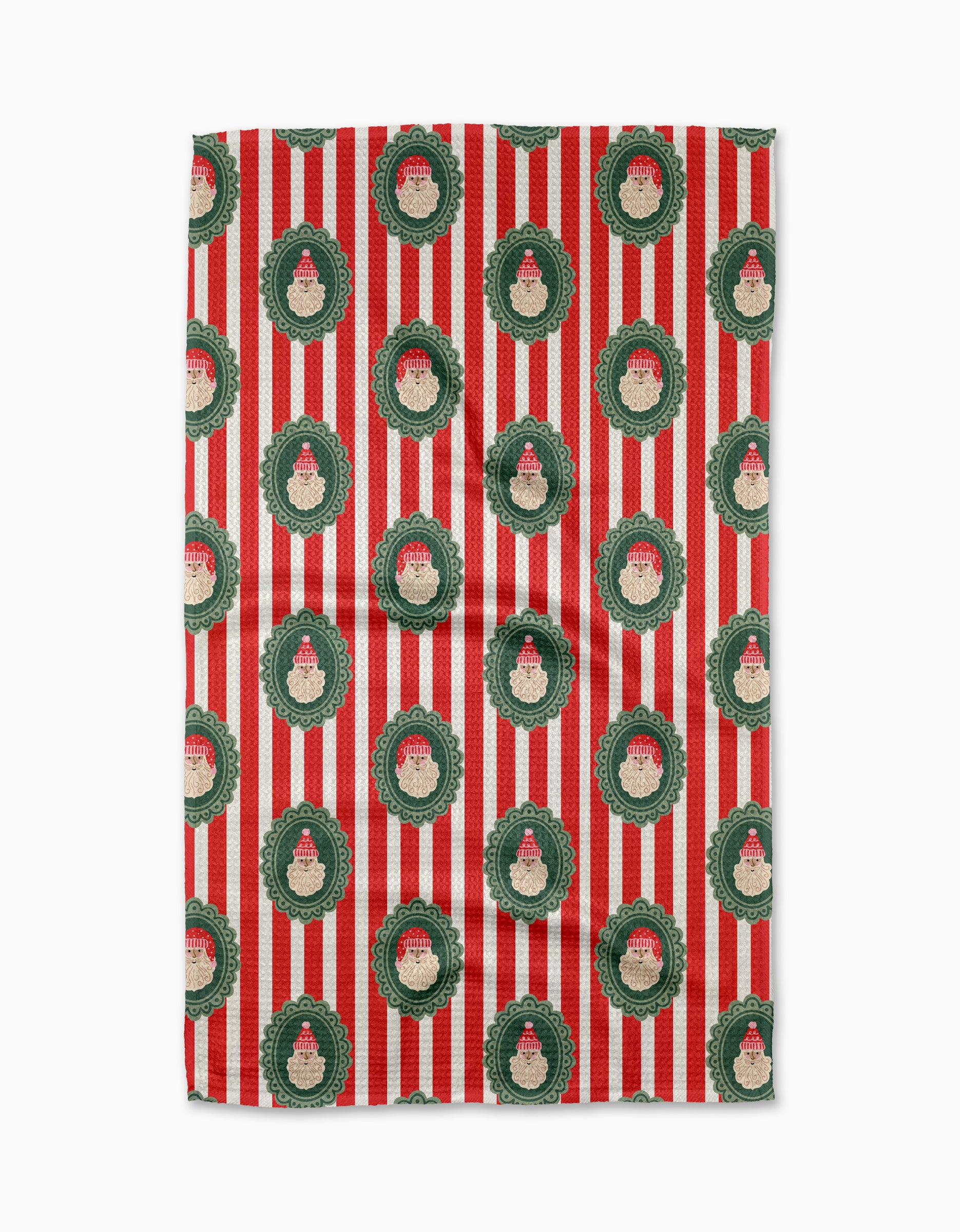 The "Striped Santa" kitchen towel by Charlie Rowan Designs is made from recycled materials and features red and white stripes with green Christmas wreaths decorated with Santa Claus faces.