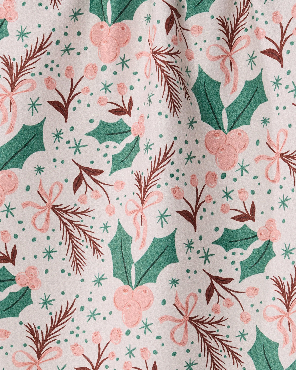 Introducing Sugarplum Florals by Geometry—a holiday-themed kitchen towel featuring festive green holly leaves, pink berries, pine branches, and pink bows on a white background in a whimsical, hand-drawn style. Thoughtfully crafted from recycled materials.