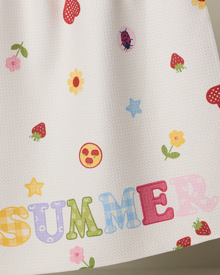 The Geometry Summer Alphabet kitchen towel features a white textured surface with colorful strawberries, flowers, stars, a ladybug, and "SUMMER" in vibrant letters—perfect for brightening your space!.