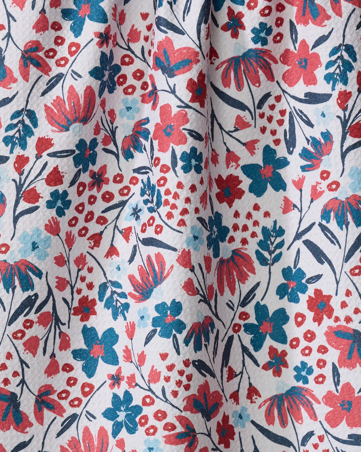 Summer Bloom by Hufton Studio features a colorful floral pattern with red, blue, and navy flowers plus green leaves on white. The slightly wrinkled, textured fabric is perfect for an eco-friendly kitchen towel made from recycled materials.