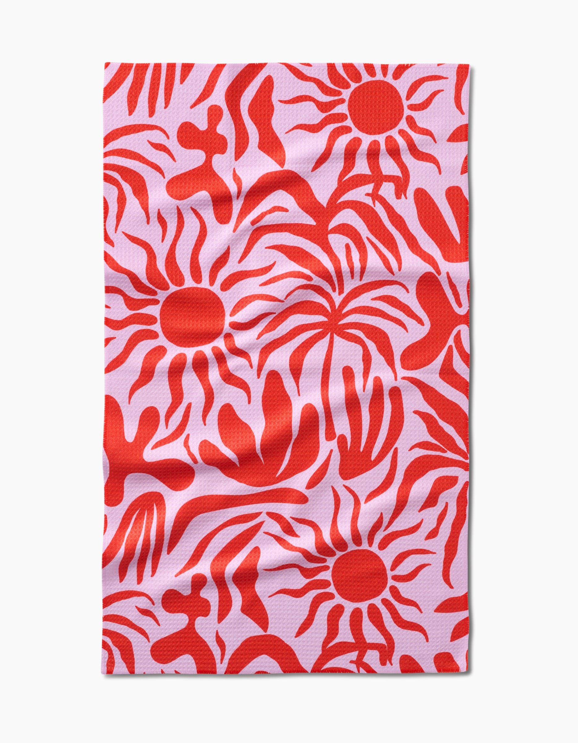 The Summer Sunset tea towel by Marina Solodka features an abstract pattern of red suns, wavy lines, and organic shapes on a pink rectangular surface, crafted from soft Geoweave™ fabric.