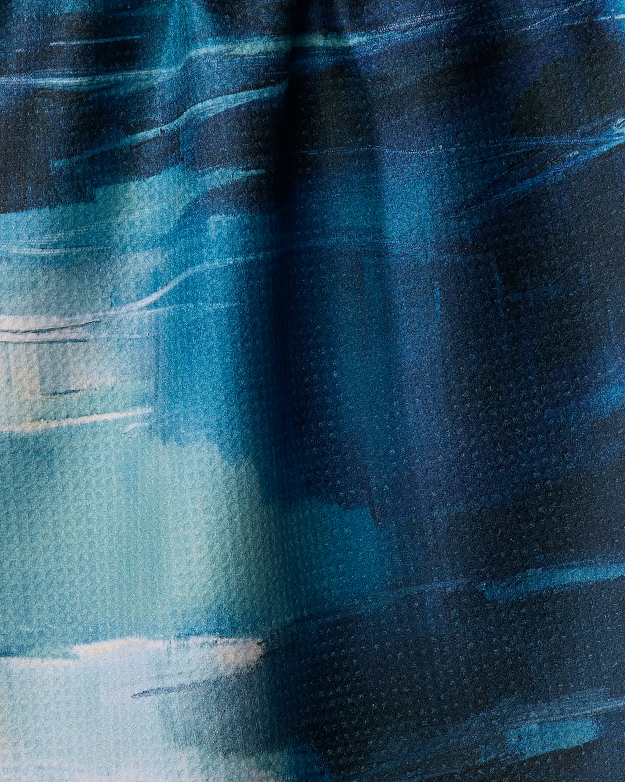 Surface Tension by Jennifer Janesko features textured blue brushstrokes with hints of white and teal, inspiring an eco-friendly tea towel that brings artistic flair and depth to your kitchen.
