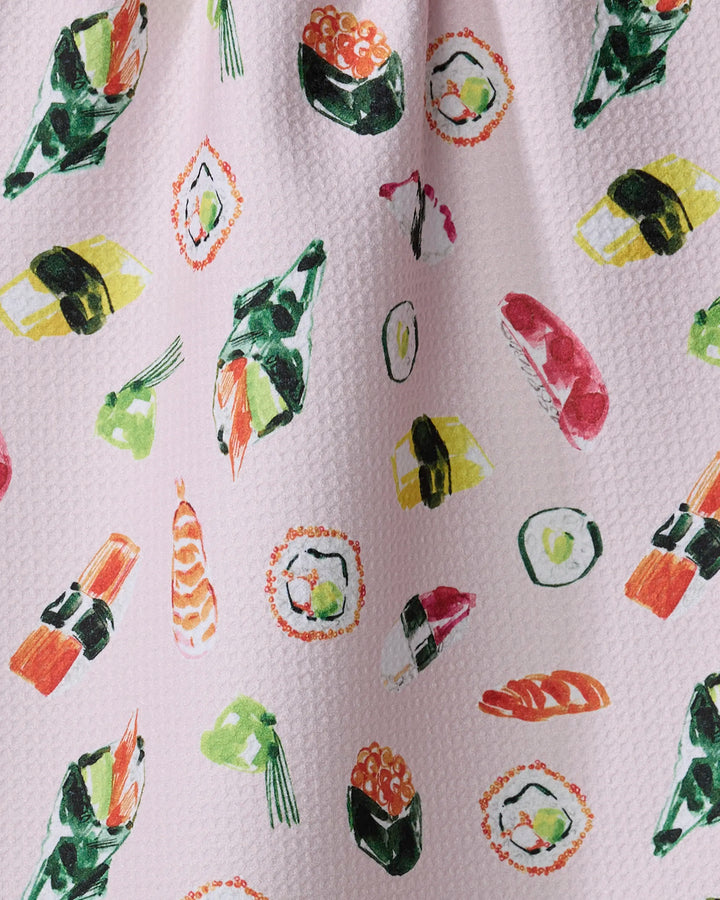 Add a pop of fun to your kitchen with the "Sushi in Tokyo" pink textured towel by Travel Write Draw by Meagan Morrison, featuring a whimsical sushi pattern in green, yellow, red, and black.