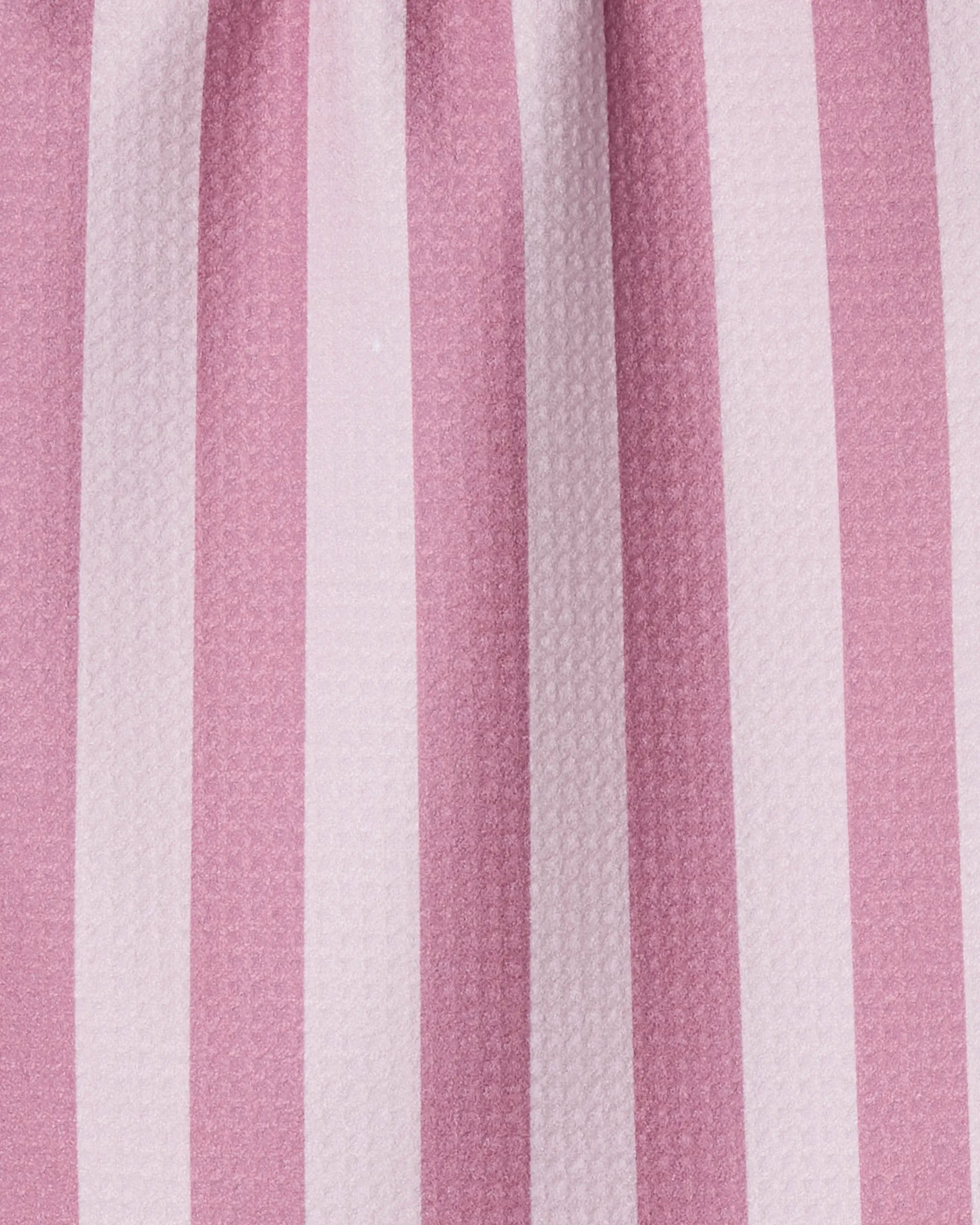 Close-up of Swan Stripe by Geometry, a kitchen towel with evenly spaced vertical pink and white stripes. The slightly raised texture makes this ultra-absorbent towel both stylish and practical for any setting.