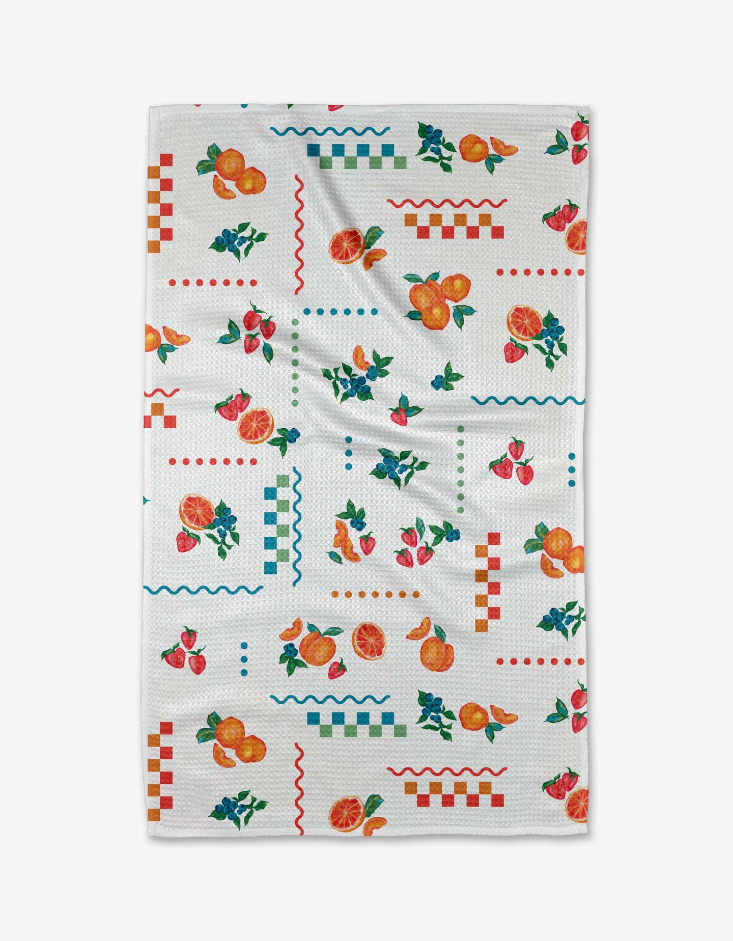 The Sweet Pickings tea towel by Aubrey Fairchild features Geoweave fabric with colorful prints of oranges, strawberries, cherries, and lively red, green, and blue checkered and wavy patterns.
