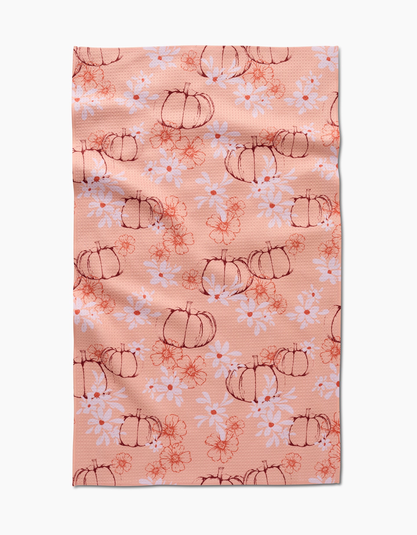 The Sweet Pumpkin Harvest by Ashley Celena is a peach recycled kitchen towel with hand-drawn pumpkins, white daisies, and orange floral accents. Ultra-absorbent with a charming, slightly wrinkled finish.