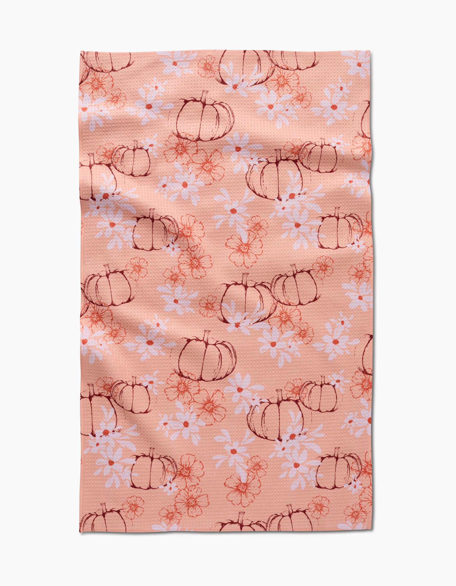 The Sweet Pumpkin Harvest by Ashley Celena is a peach recycled kitchen towel with hand-drawn pumpkins, white daisies, and orange floral accents. Ultra-absorbent with a charming, slightly wrinkled finish.