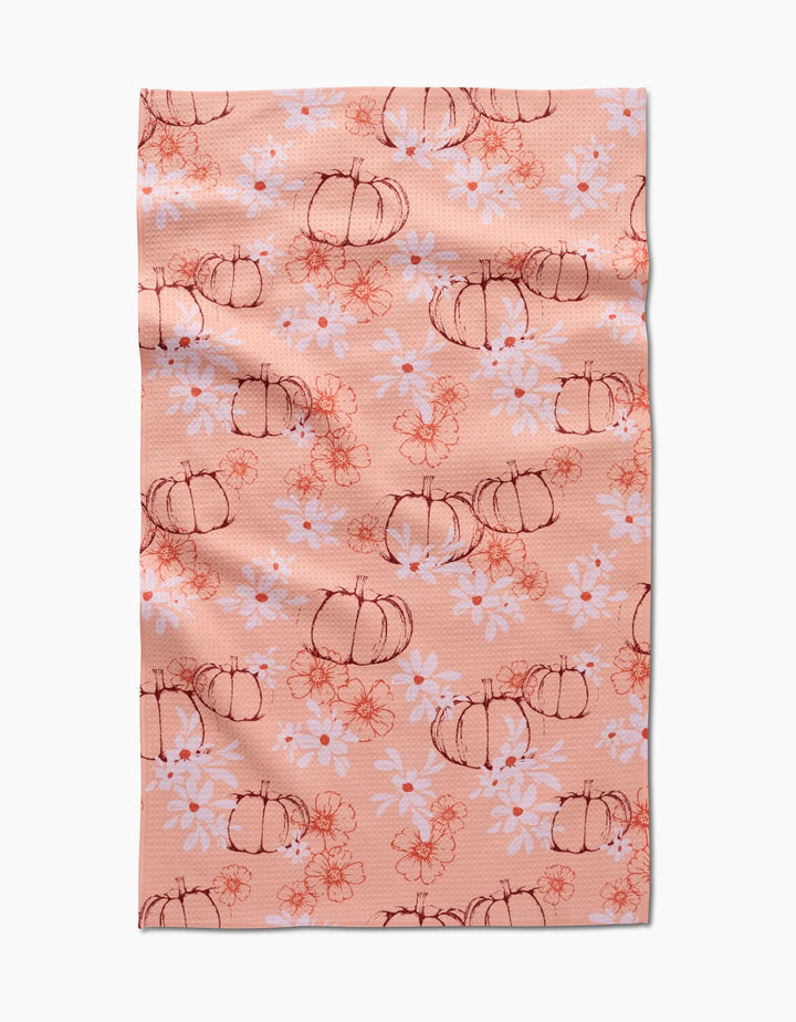 The Sweet Pumpkin Harvest by Ashley Celena is a peach recycled kitchen towel with hand-drawn pumpkins, white daisies, and orange floral accents. Ultra-absorbent with a charming, slightly wrinkled finish.