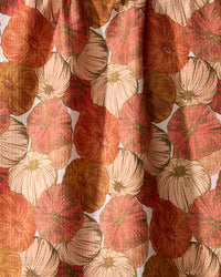 The Geometry Tendril kitchen tea towel features overlapping pumpkins in orange, rust, cream, and gold with detailed lines and textures.
