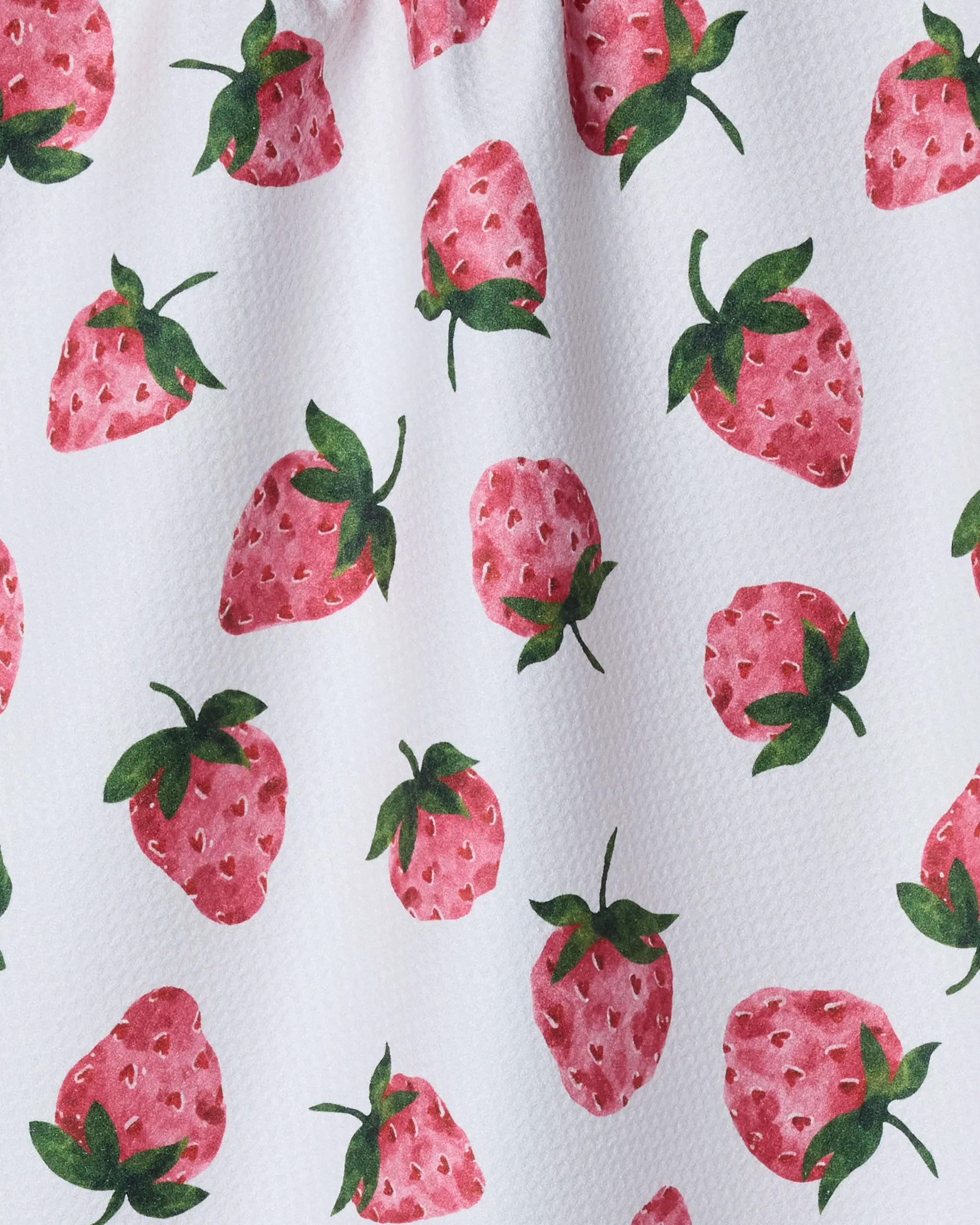 Geometry's "The Sweetest" is a white tea towel adorned with pink strawberries and green leaves, made from ultra-absorbent recycled materials.