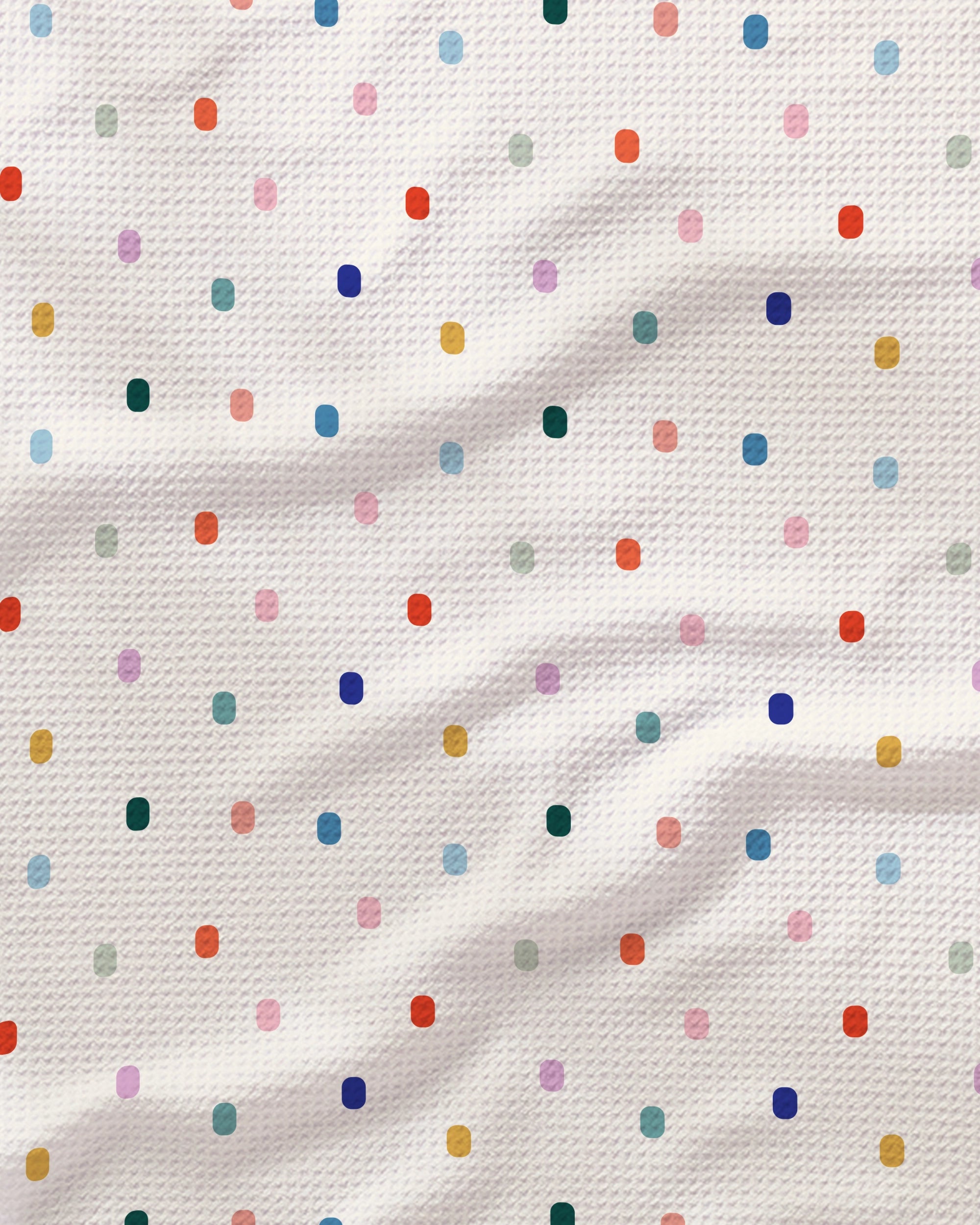 Introducing Tile Shuffle by Geometry: This white textured tea towel, named "Tile Shuffle," features a playful grid of multicolored polka dots in vibrant shades of red, blue, green, purple, yellow, and pink. Crafted from absorbent quick-drying fabric, its gentle wavy folds enhance both the towel's functionality and the signature charm that Geometry is known for.