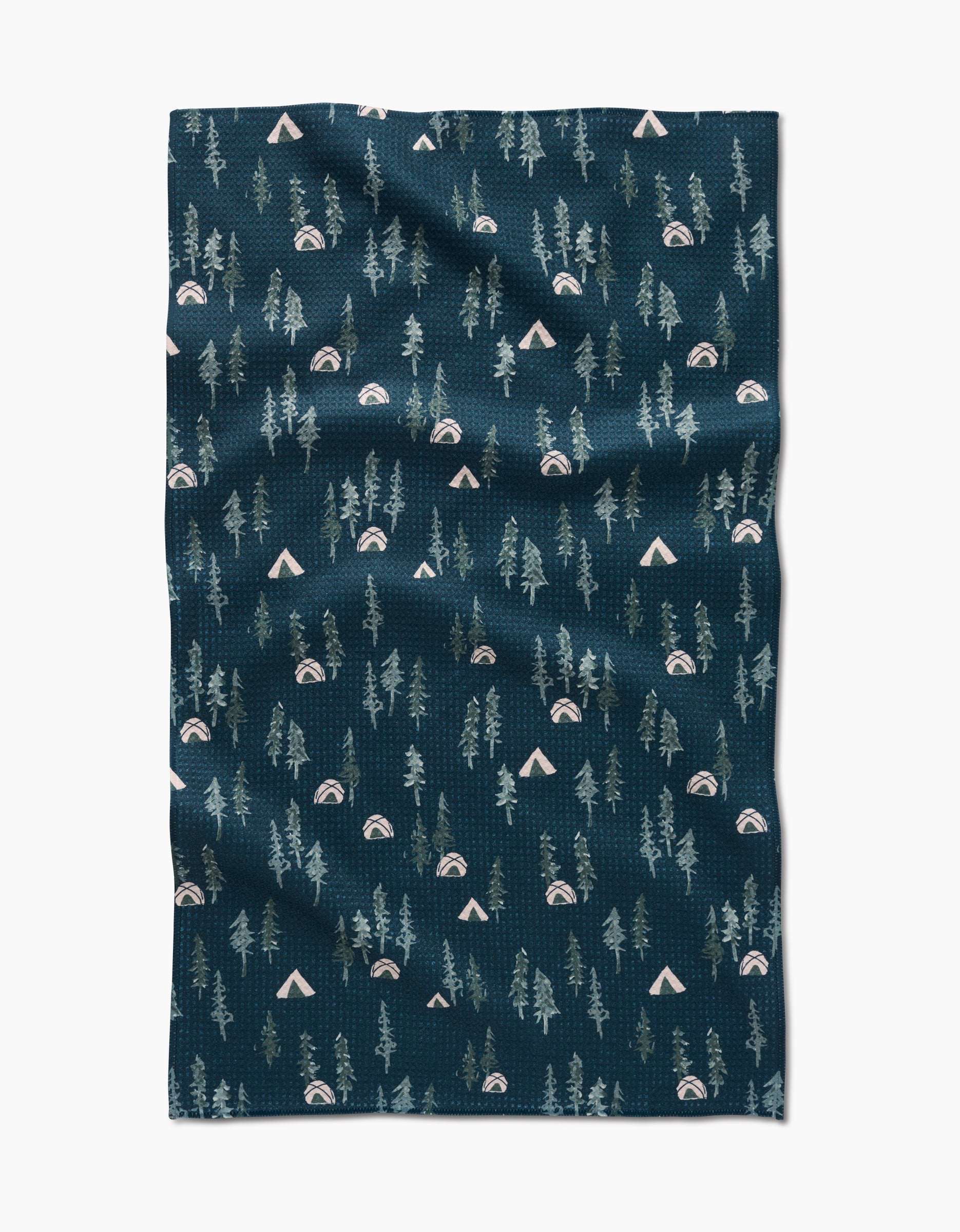 The Twig + Spark Tiny Tents blanket is crafted from ultra-absorbent Geoweave fabric in navy blue, featuring a whimsical pattern of green trees, beige tents, and rainbows inspired by outdoor camping.