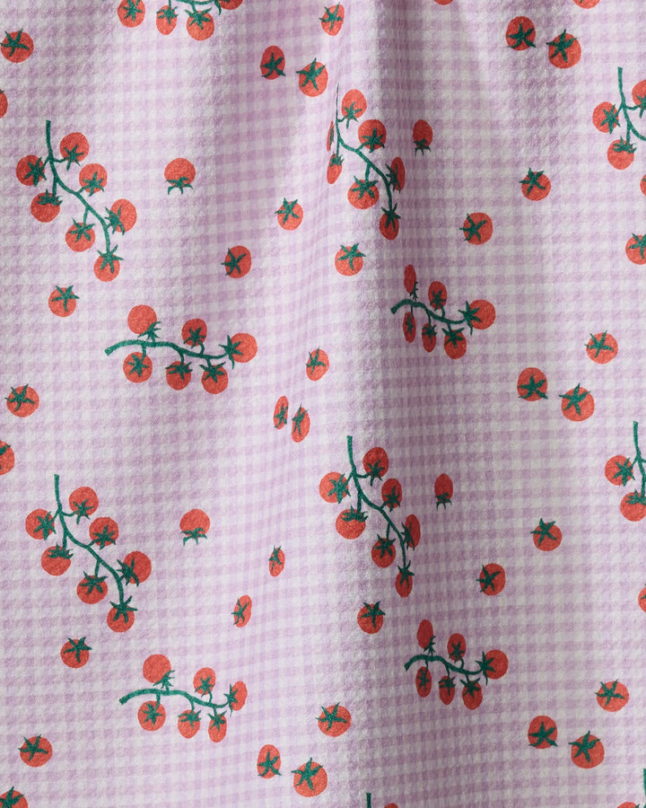 The Tomato Gingham kitchen towel by Brittany Jepsen features a light purple and white gingham pattern with small red tomatoes and green stems, crafted from recycled materials.