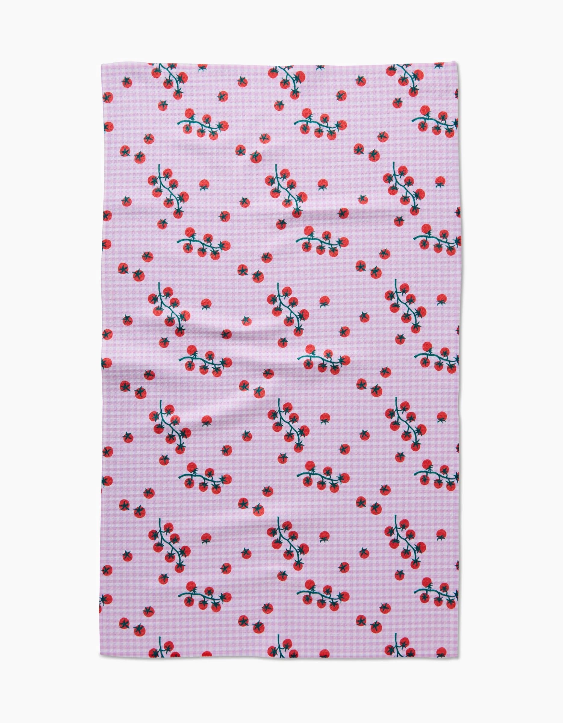 The Tomato Gingham by Brittany Jepsen is a pink and white checkered Geoweave fabric with small red tomatoes and green leaves, made from recycled materials for an eco-friendly touch.