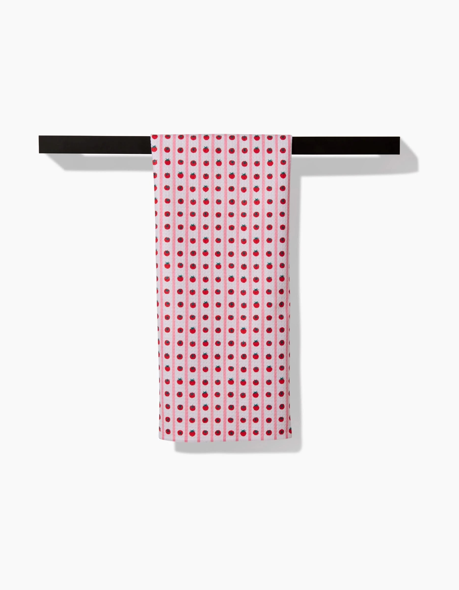 A white Brittany Jepsen Tomato Stripes tea towel, featuring evenly spaced red stripes, hangs neatly over a black bar against a white background. Made from absorbent Geoweave™ fabric.