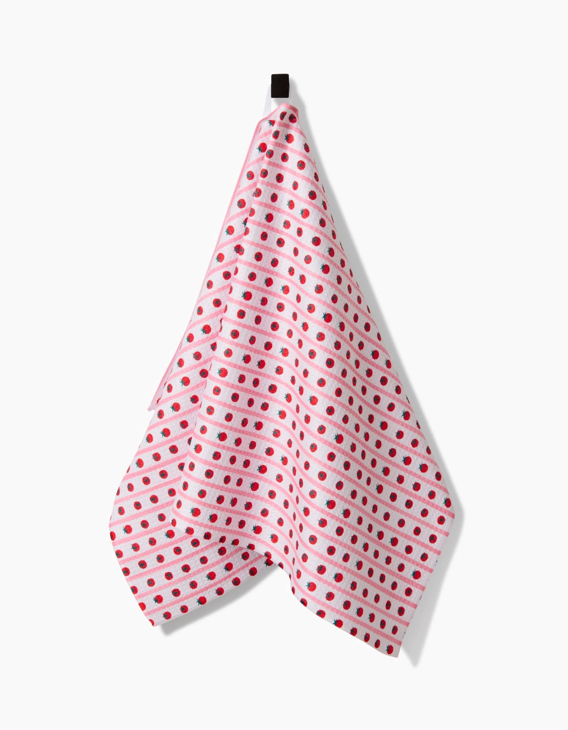 A Brittany Jepsen Tomato Stripes tea towel made from Geoweave™ fabric hangs from a black loop against a white background, featuring bold red and pink stripes.
