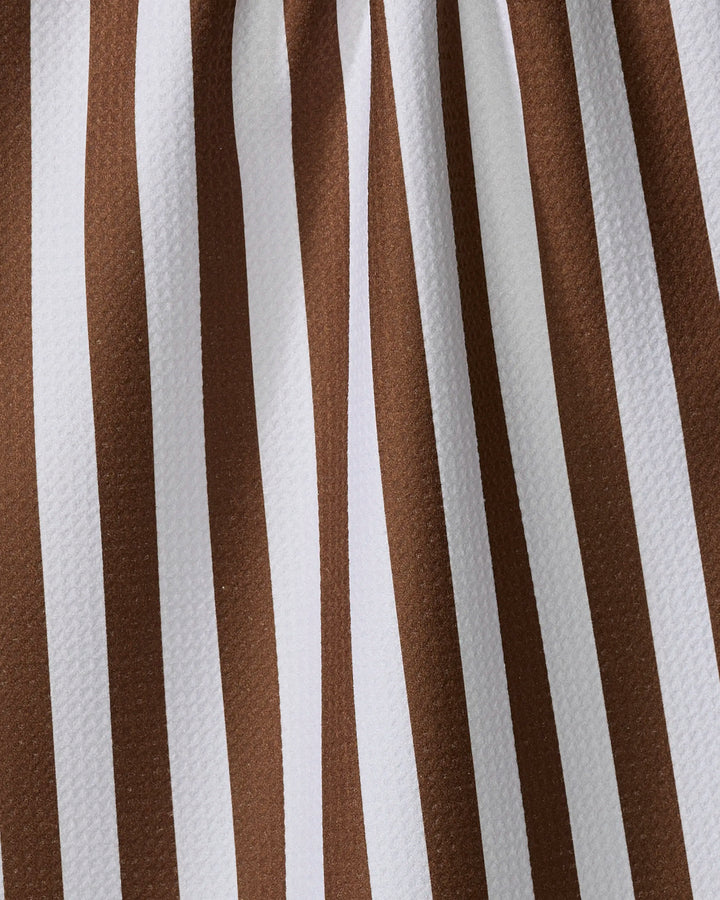 Close-up of the Toni Stripe tea towel by Kailee Wright, showcasing vertical brown and white stripes on textured, quick-drying fabric made from recycled materials.