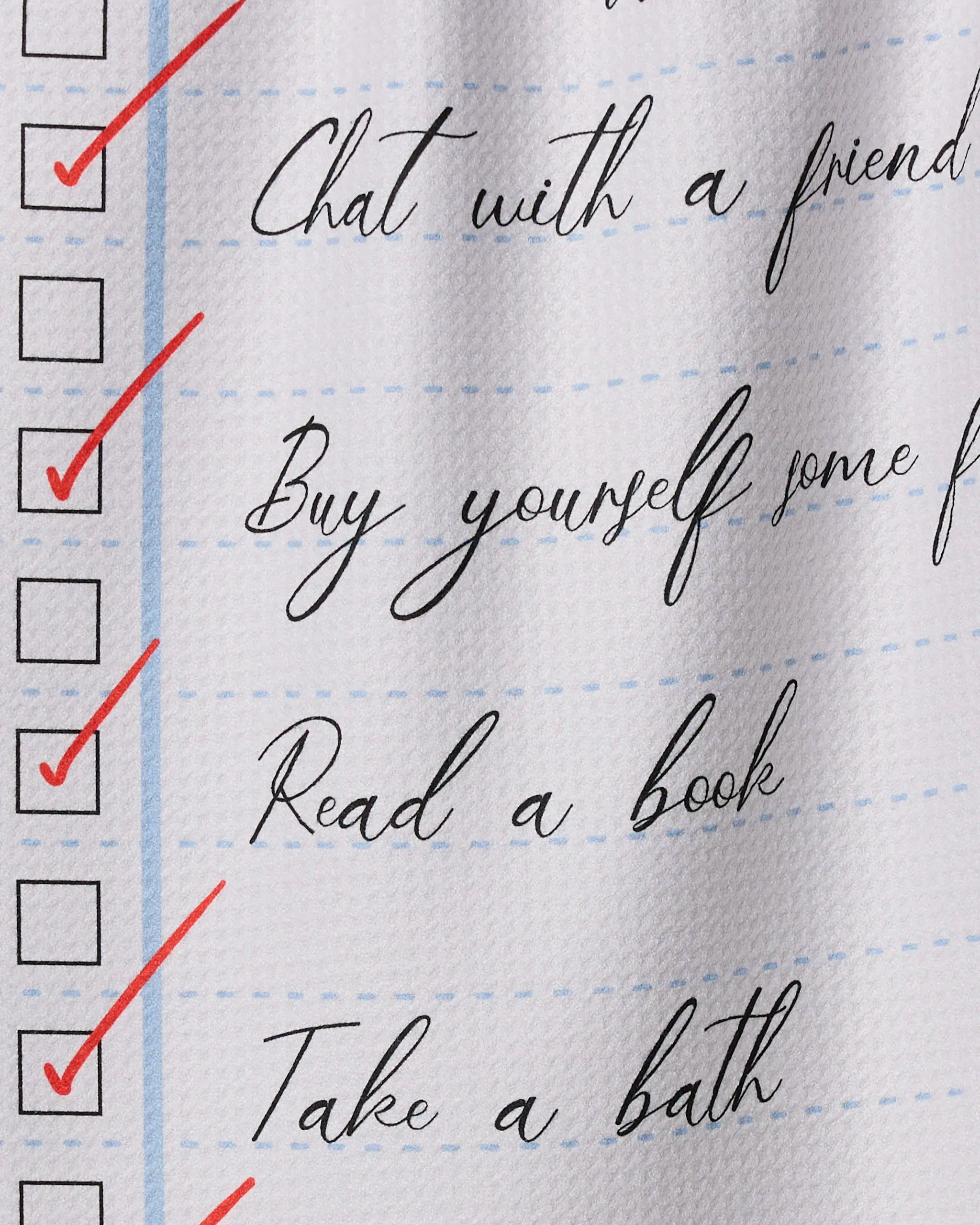 Treat yourself with Geometry’s “Treat Yourself” kitchen towel, featuring charming illustrations and red check marks beside self-care tasks like chatting with a friend, buying flowers, reading a book, and taking a bath—printed on recycled fabric.