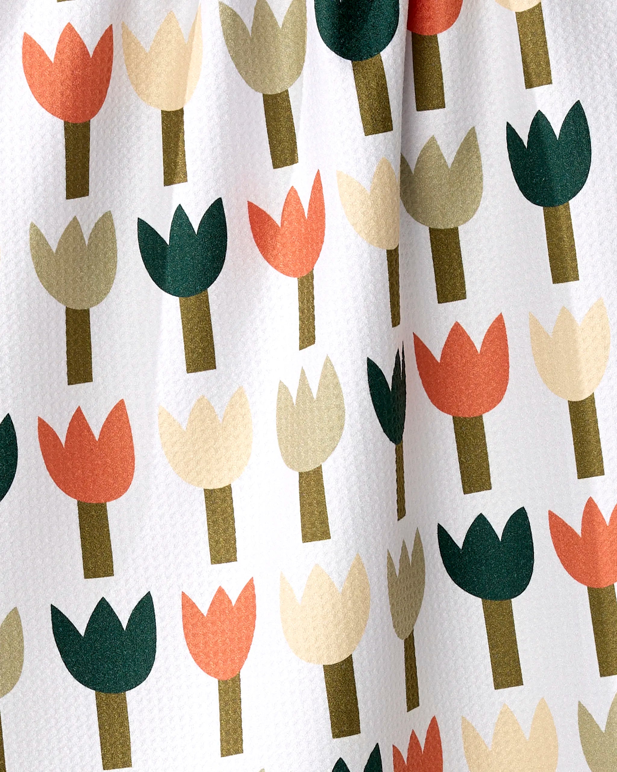 The Rachel Parker Tulip Row tea towel features a white textured design with stylized tulips in green, orange, beige, and peach. Made from recycled materials for an eco-friendly touch.