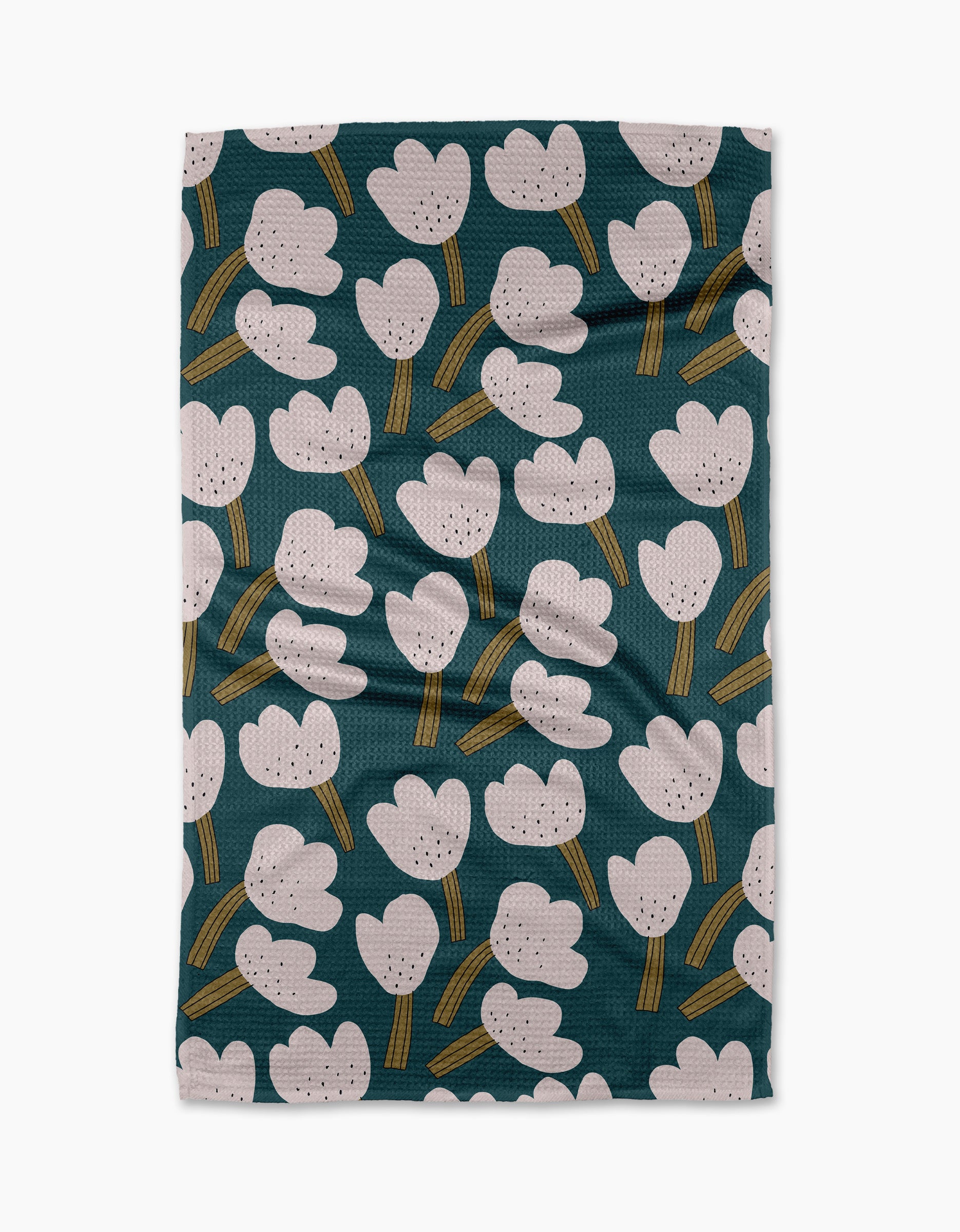 The "Tulips" tea towel by Jennifer Bouron is a rectangular, recycled-fabric towel with a dark green base, modern white and pink abstract tulips, yellow-green stems, and a slightly wrinkled texture.