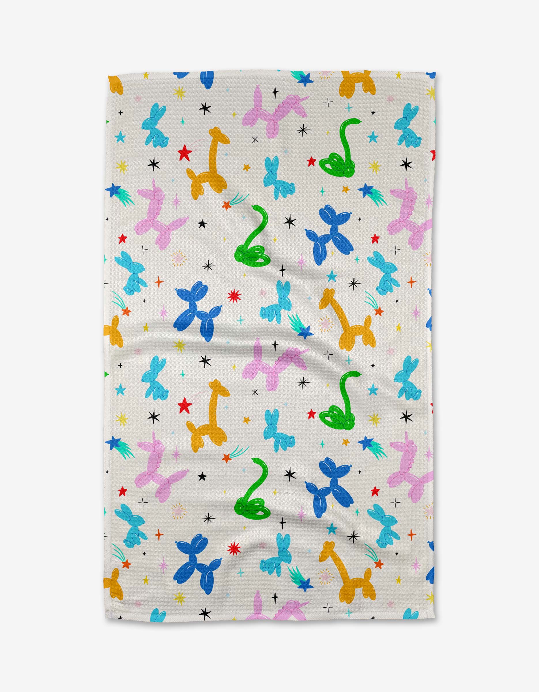 The Vaishali Design Studio Twisties towel is ultra-absorbent and white, featuring a playful pattern of balloon animals—blue and pink dogs, yellow giraffes, green snakes—and red, blue, and black stars. Perfect as a fun tea towel for your kitchen.