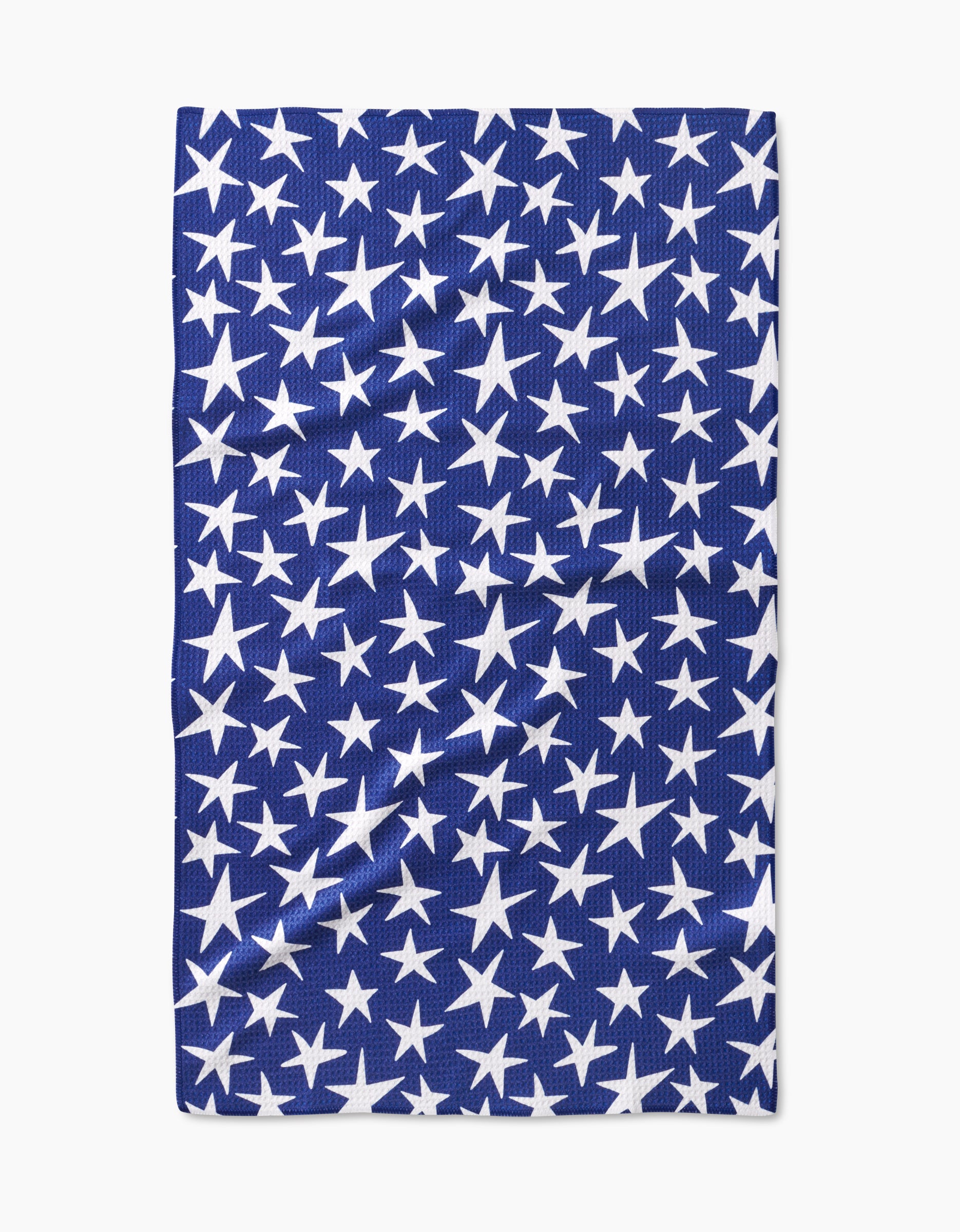 The Mindfulnice USA Stars tea towel features a blue Geoweave fabric with white stars in various sizes, shown laying flat with slight creases.