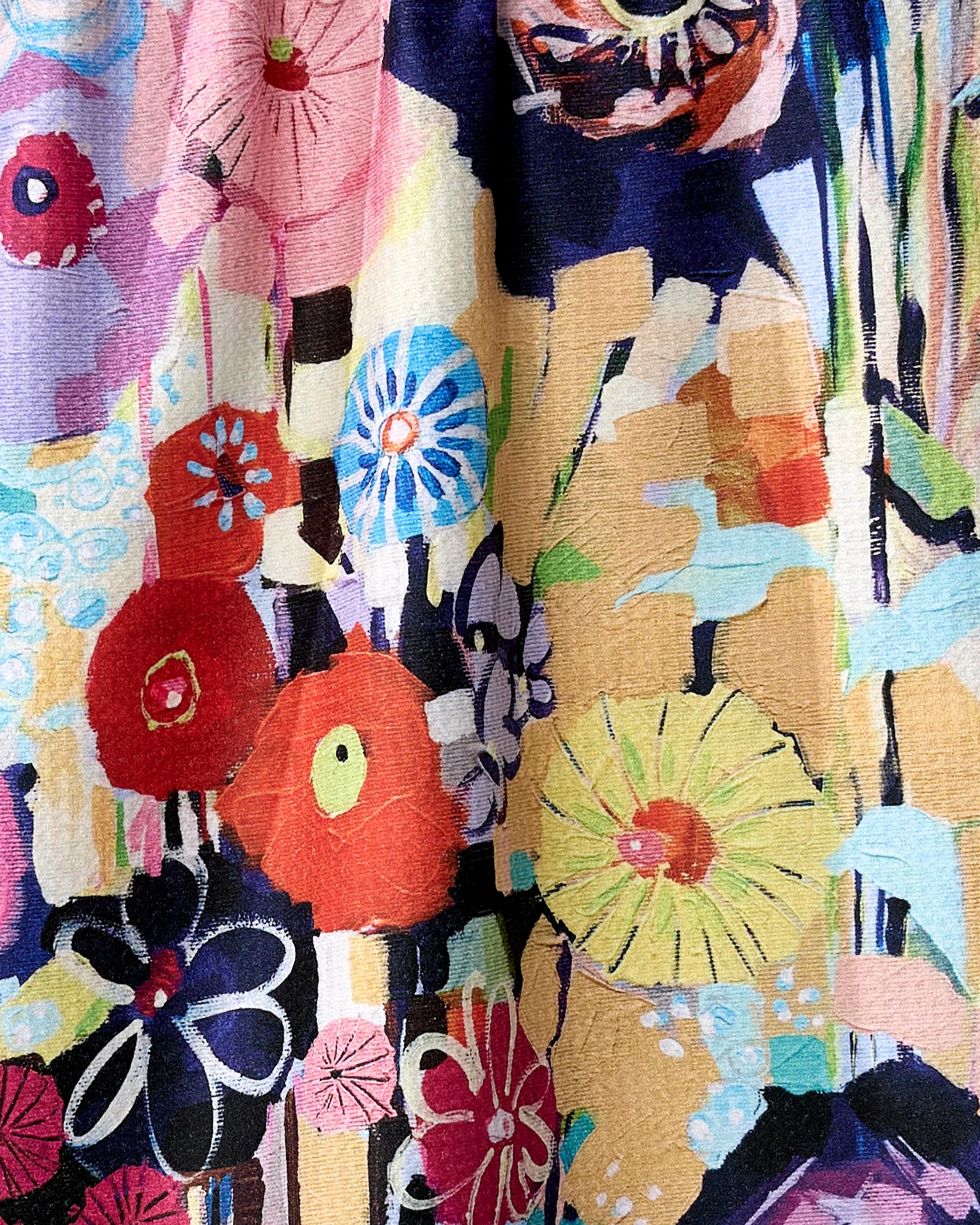 The "Vera" kitchen towel by Ania Zwara Art features bold abstract floral shapes in red, blue, yellow, black, and pink with expressive brushstrokes on a textured recycled background.