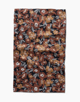 The Hufton Studio Vintage Floral Natural Tea Towel features a rectangular Geoweave fabric with a dense floral print in brown, orange, white, and gray on black. The ultra-absorbent towel has a slightly wrinkled texture.