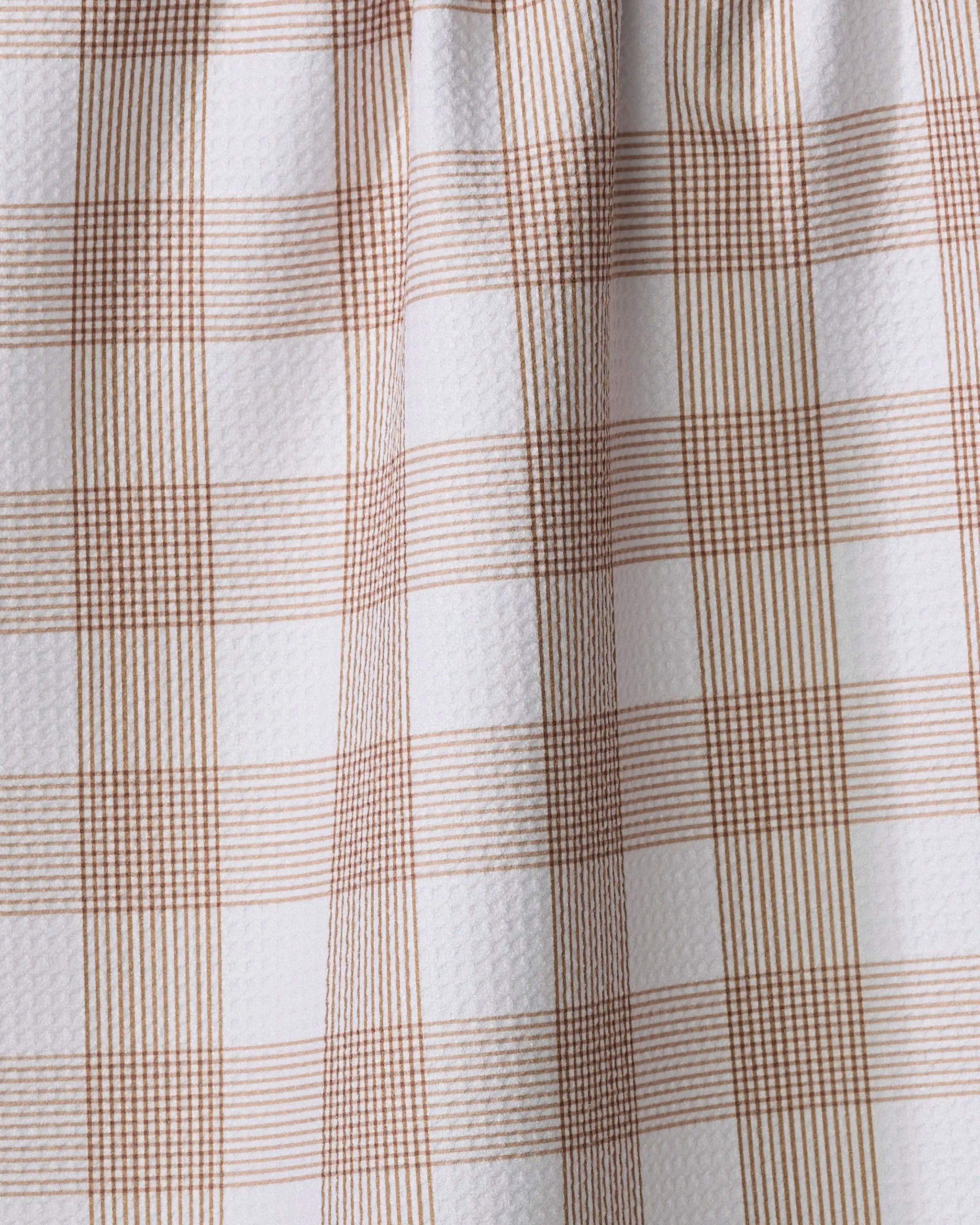 A close-up of Hufton Studio’s Vintage Gingham Natural tea towel, showing brown and white squares made from ultra-absorbent, recycled materials with a textured, woven look.