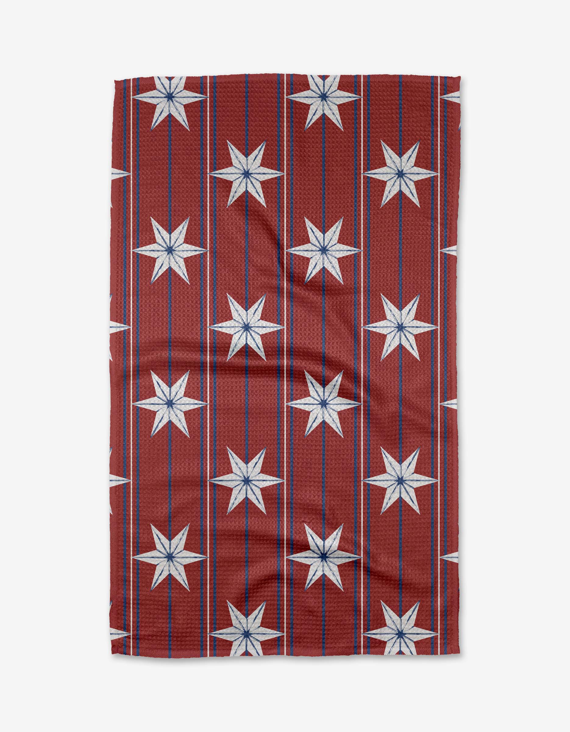 The Ashley Celena Vintage Stars tea towel showcases a red background with vertical blue lines and white eight-pointed stars in a grid. Made from ultra-absorbent fabric, it’s shown slightly wrinkled on a white backdrop.