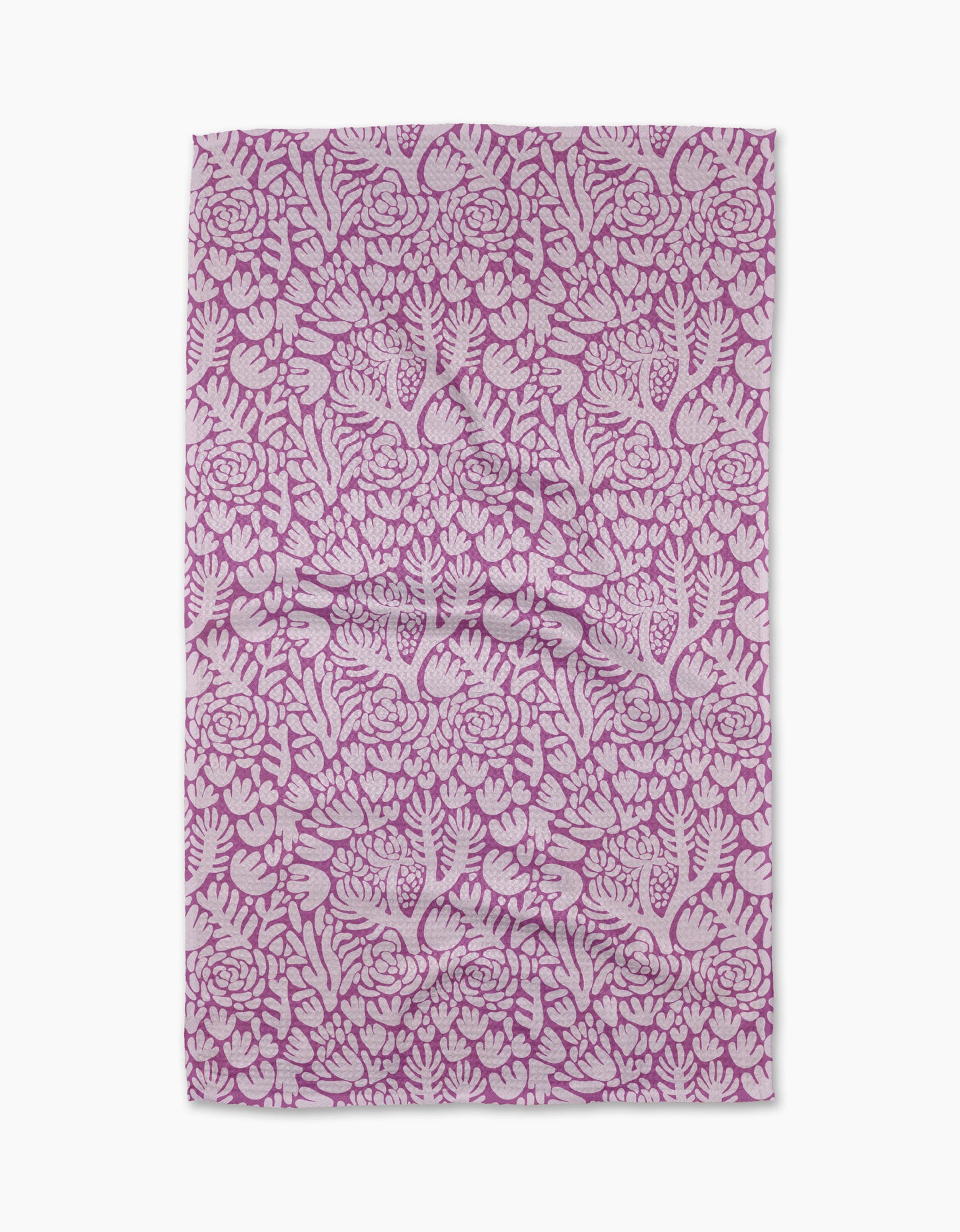 The Violet Paper Flowers tea towel by Katie OShea features an intricate floral pattern in pink and white, with densely arranged flowers and leaves—perfect for adding charm to any kitchen.