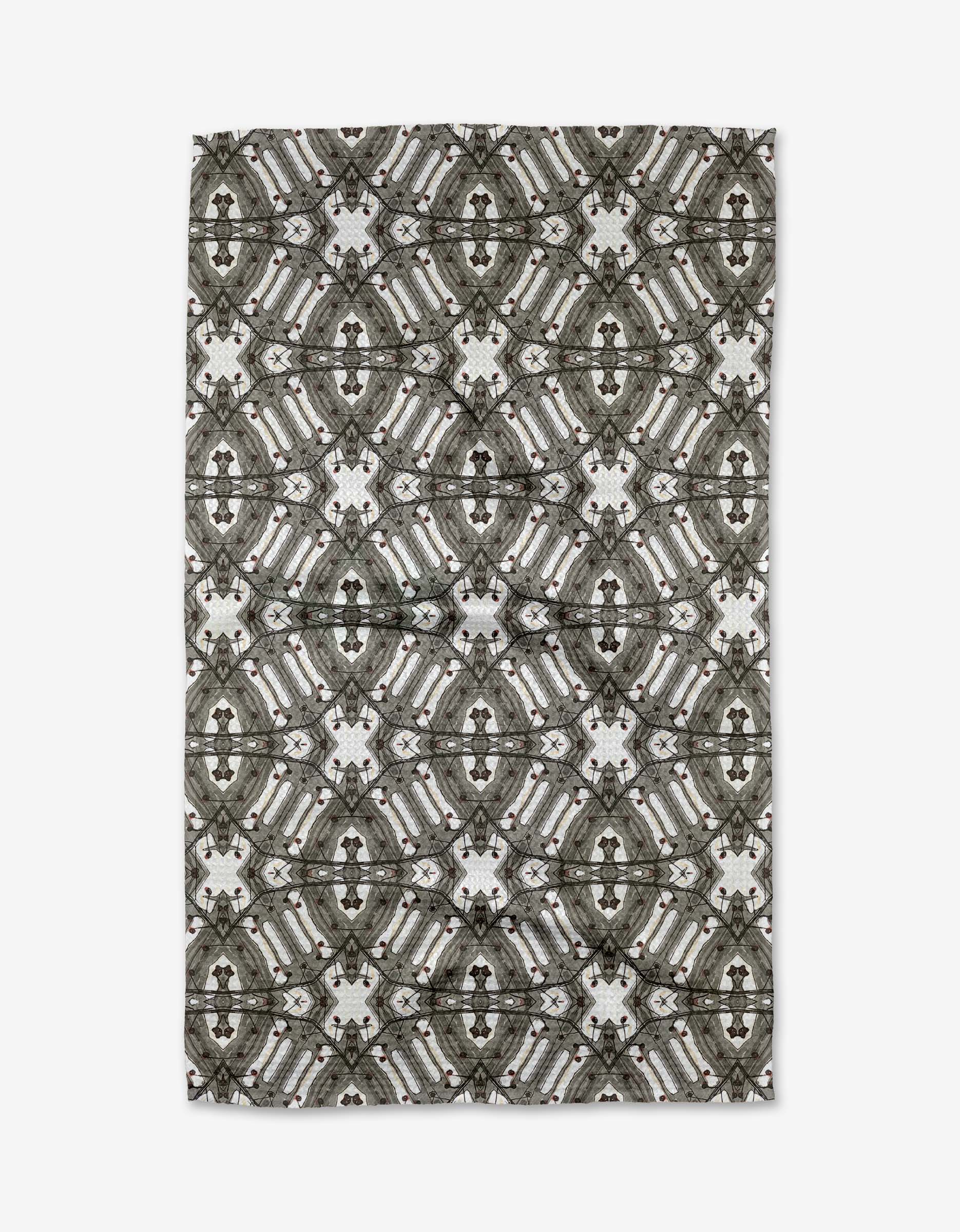 The Walk The Line Shimmy rug by Katherine Berkeley features a symmetrical geometric pattern in gray, black, and white, offering an intricate and stylish accent reminiscent of ornate dish towel designs.