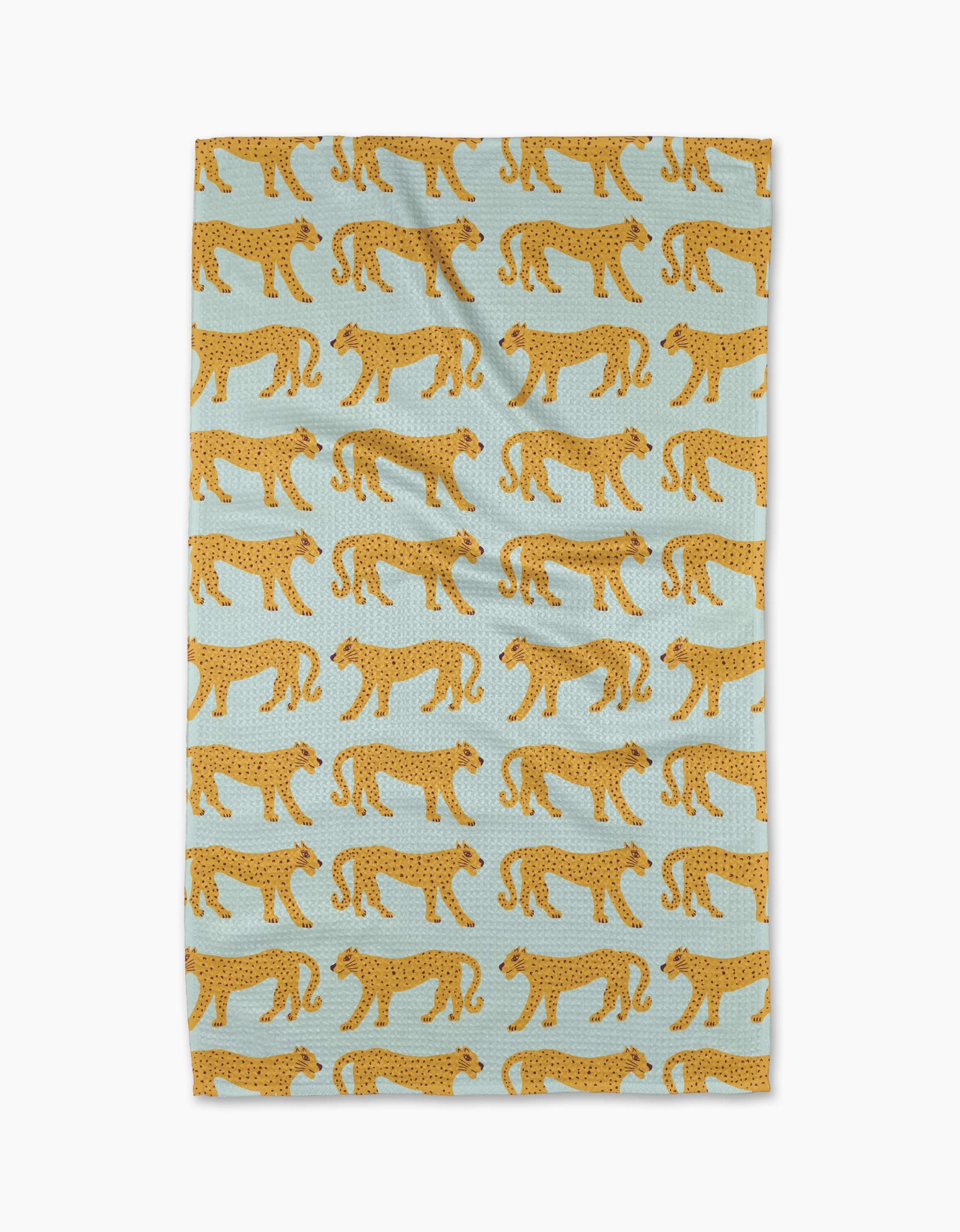 The Walking Cheetah tea towel by Jasmine Blooms Designs features a light blue background with a repeating pattern of stylized yellow cheetahs with black spots walking in alternating directions.