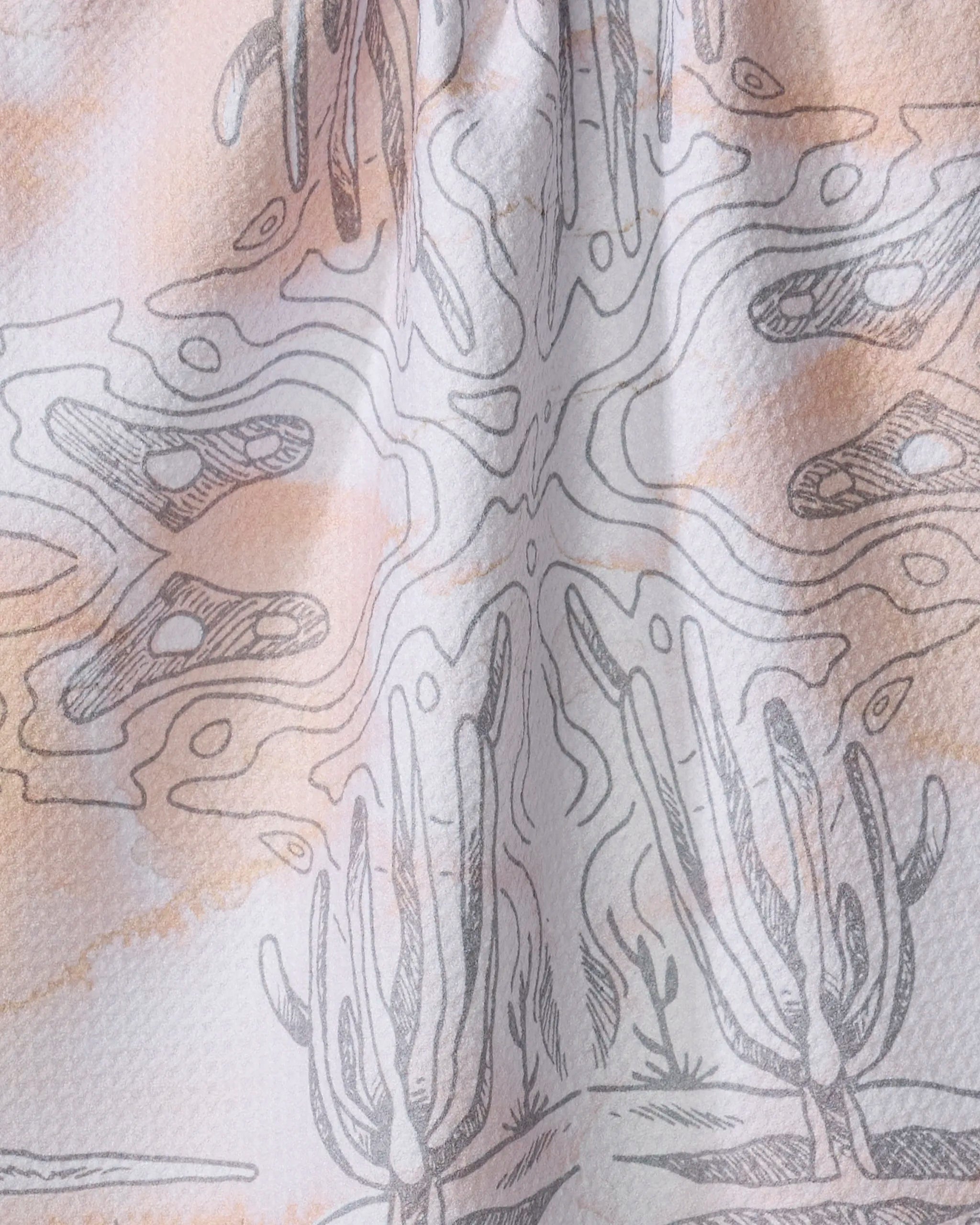 A close-up of Skye Walker’s Waves fabric, made from recycled materials with an abstract desert pattern of hand-drawn cacti and wavy lines in soft earth tones—ideal as a stylish kitchen towel or tea towel.