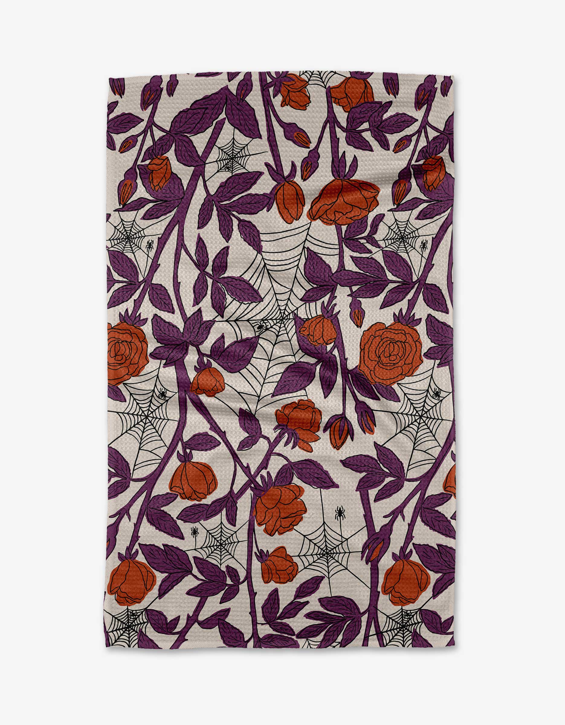 The Kayla Ann Webs and Roses towel is ultra-absorbent and features an intricate pattern of orange roses, purple leaves, and black spider webs with small spiders on a white background.