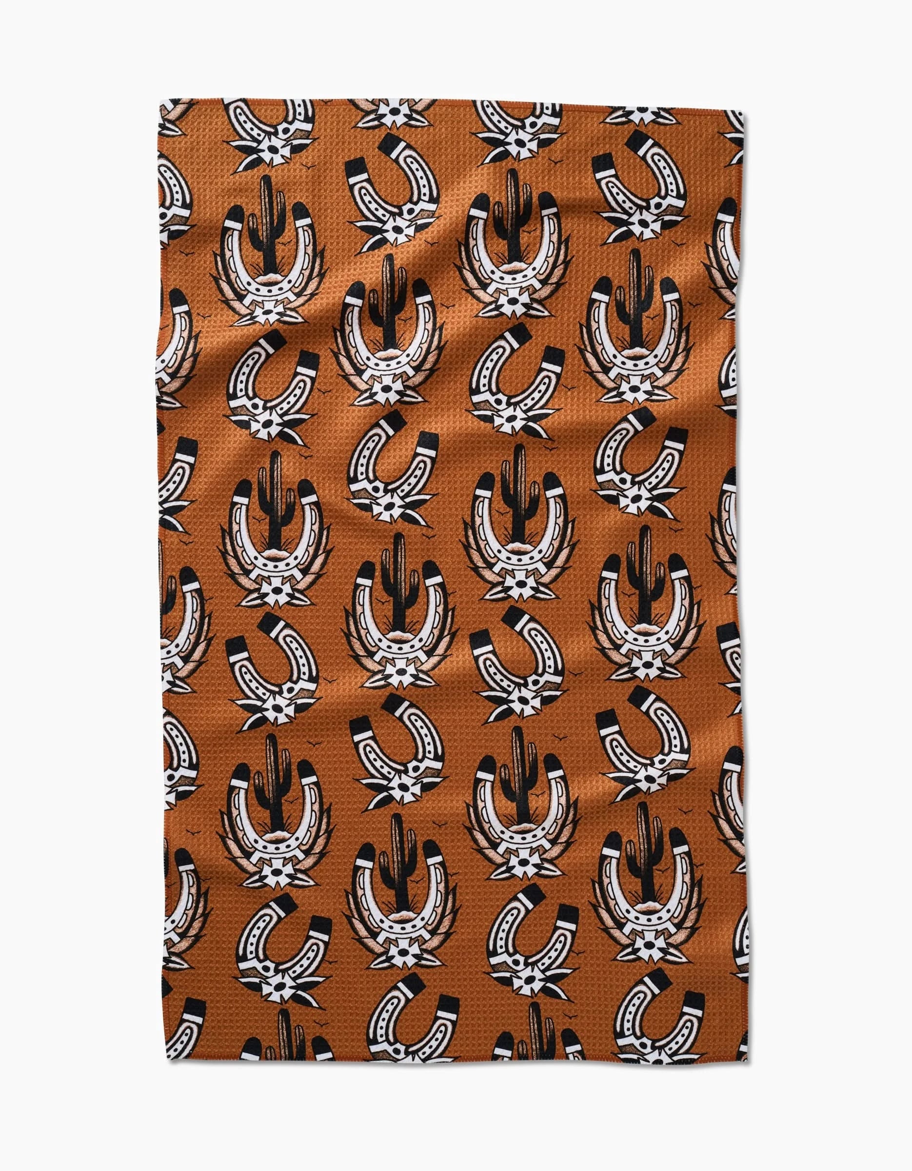 The Cole Strem Western Horseshoes rectangular tea towel, made of ultra-absorbent Geoweave fabric, features a repeating black and white horseshoe and feather pattern, shown flat against a white background.