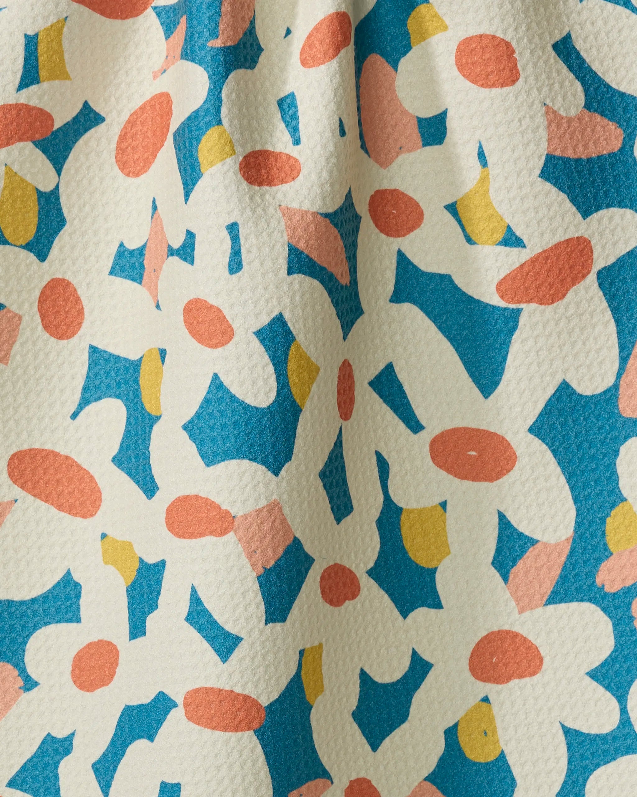 Whoopsie Daisy by Kelsey Weigl: an ultra-absorbent towel with a colorful abstract floral pattern in white, peach, and yellow on textured blue, featuring a printed design that looks slightly wrinkled for added style.