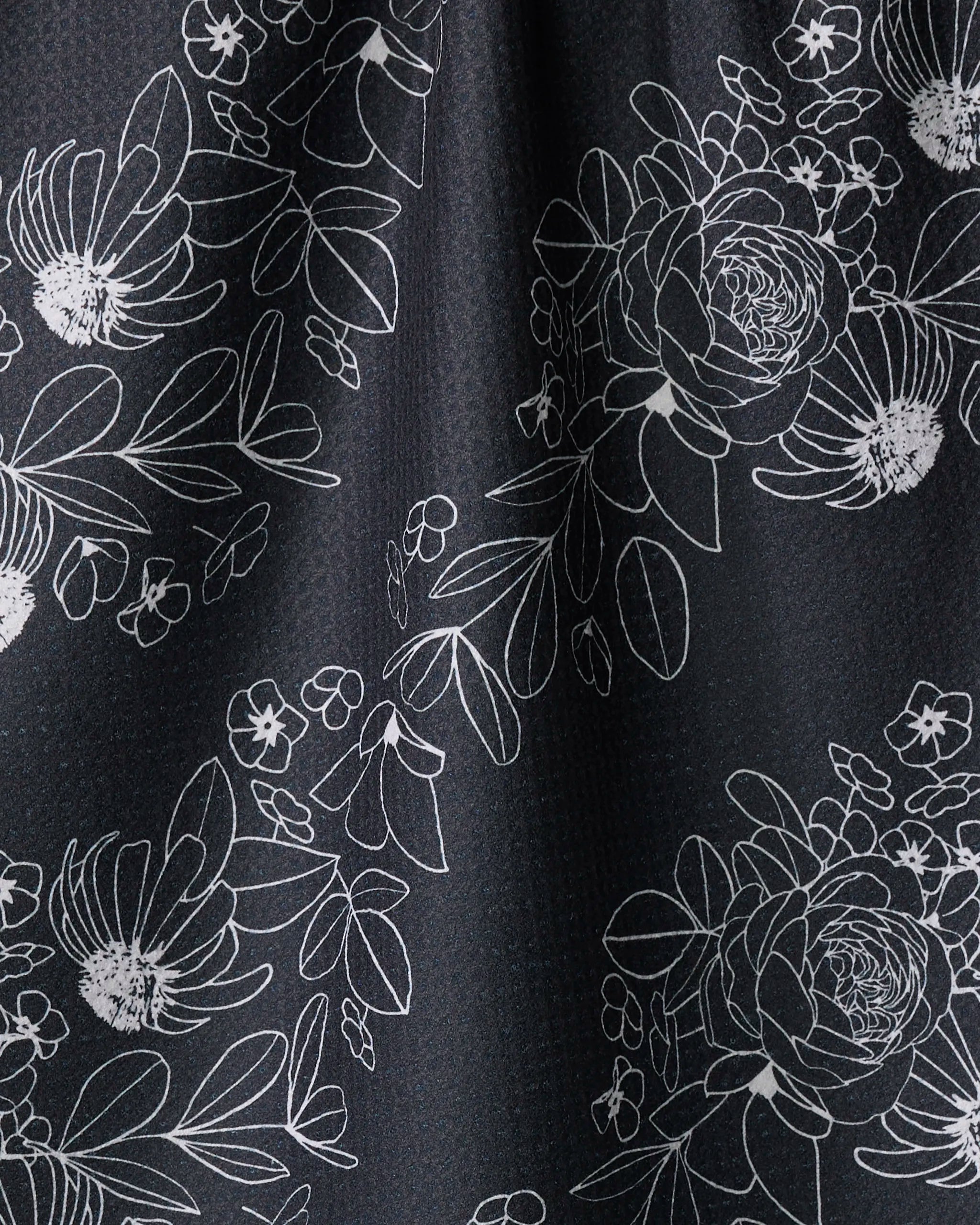 The "Wild and Wonderful" towel by Rosa Kichline features white floral and leaf outlines on a dark, textured background, offering an elegant, ultra-absorbent addition to your kitchen décor.