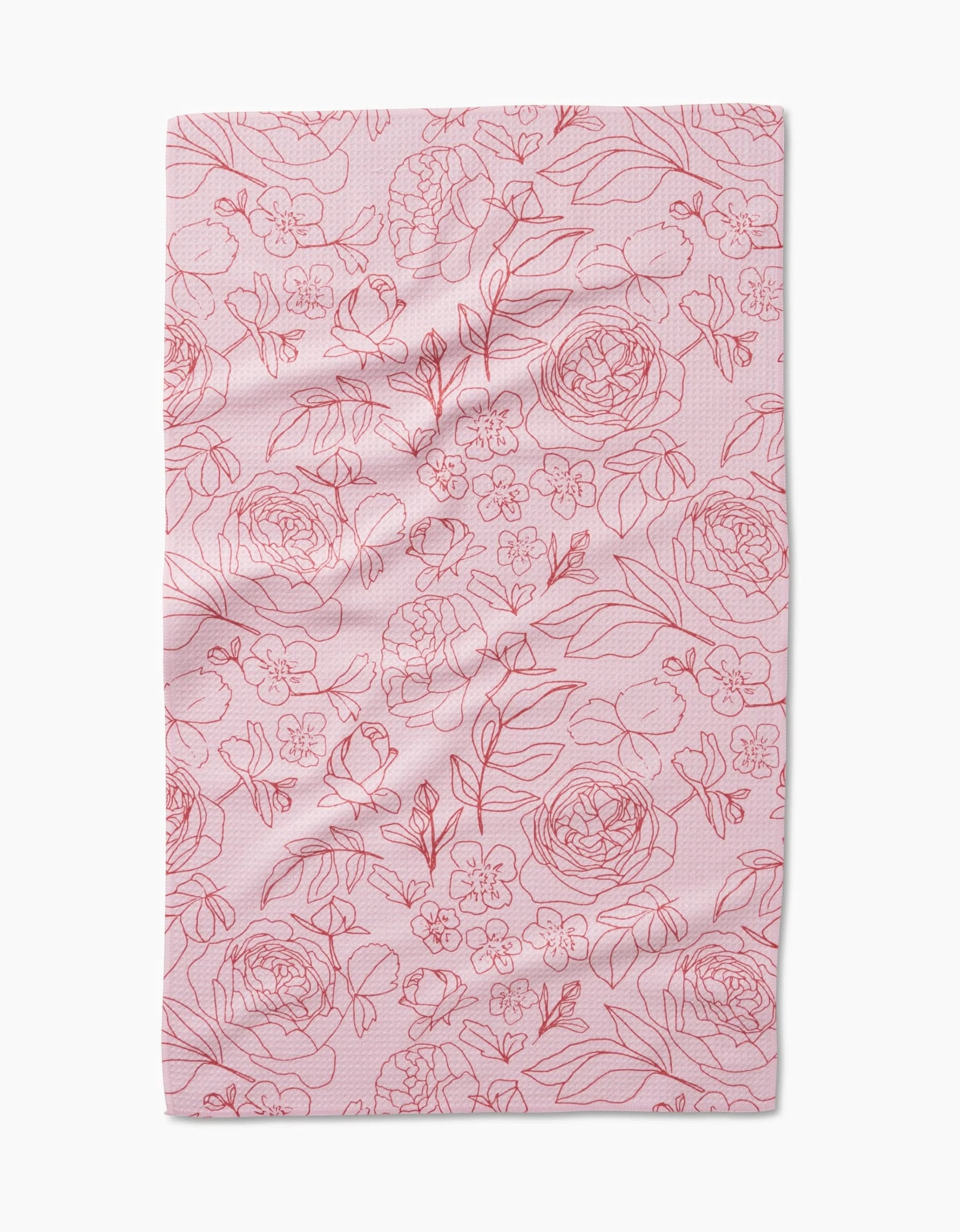 The Wild Roses tea towel by Janna Sue Design is pink and rectangular, adorned with red-outlined flowers and leaves across its recycled material surface.