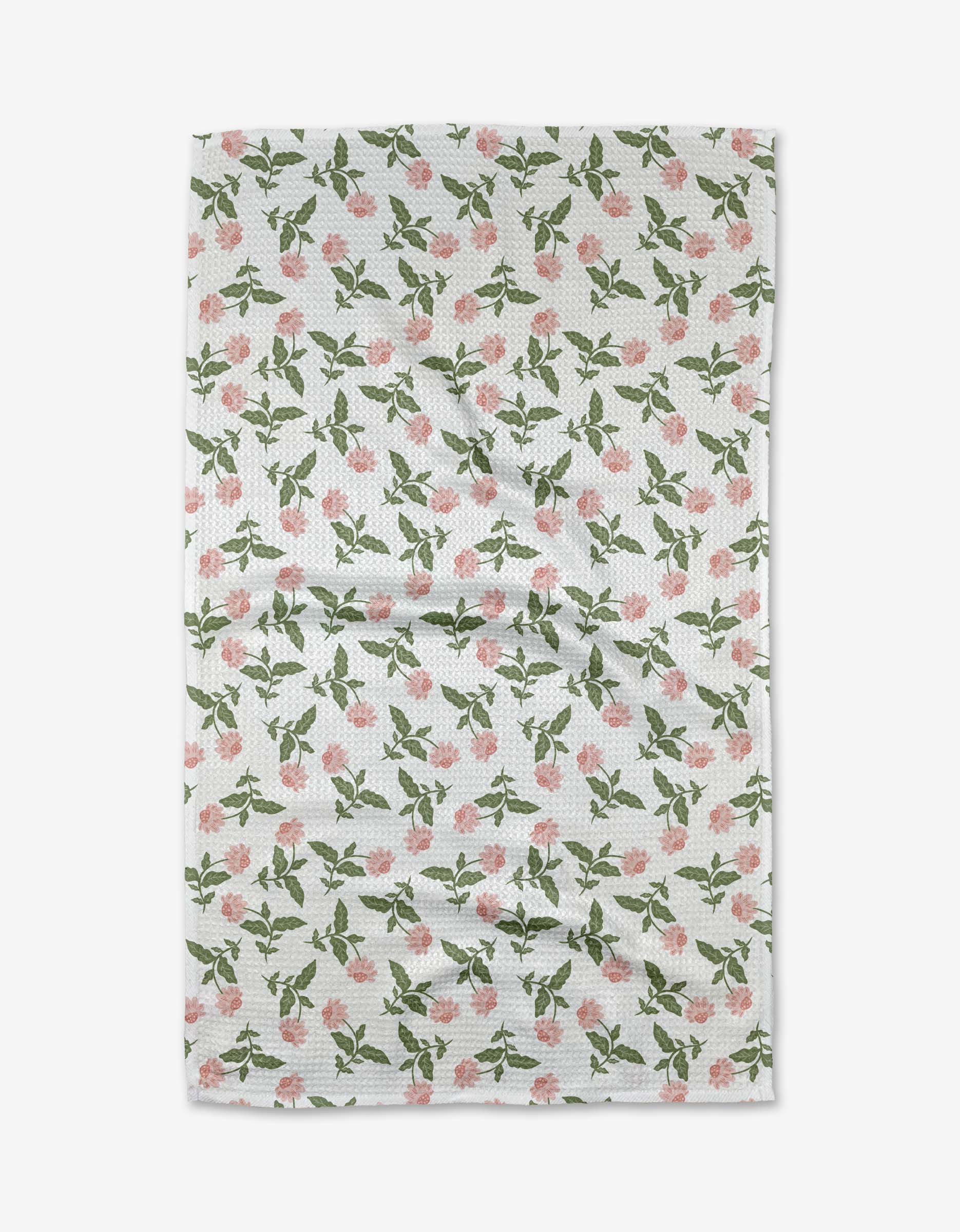 The Danelys Sidron Wildflower Vine Blush tea towel is white, made with ultra-absorbent Geoweave fabric, and features a textured design of pink flowers and green leaves in a repeating pattern across the surface.