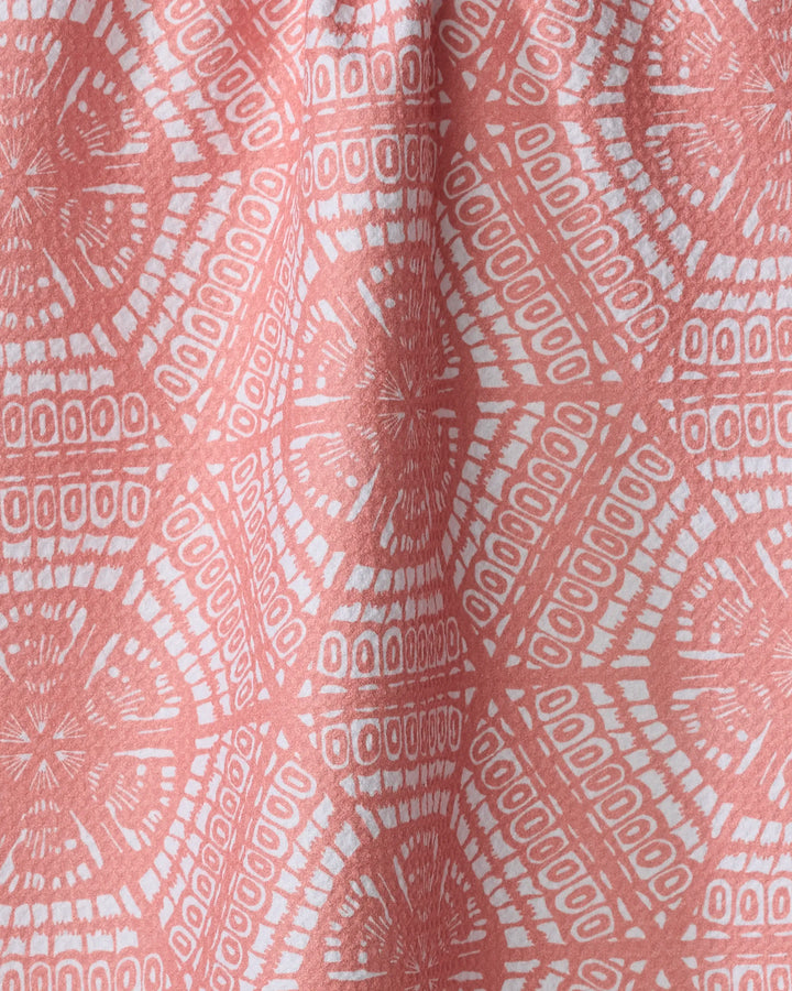 The Wings towel by Renee Fly features pink and white geometric circular and linear patterns with symmetrical, intricate details. Quick-drying and slightly draped, it’s perfect for everyday use.