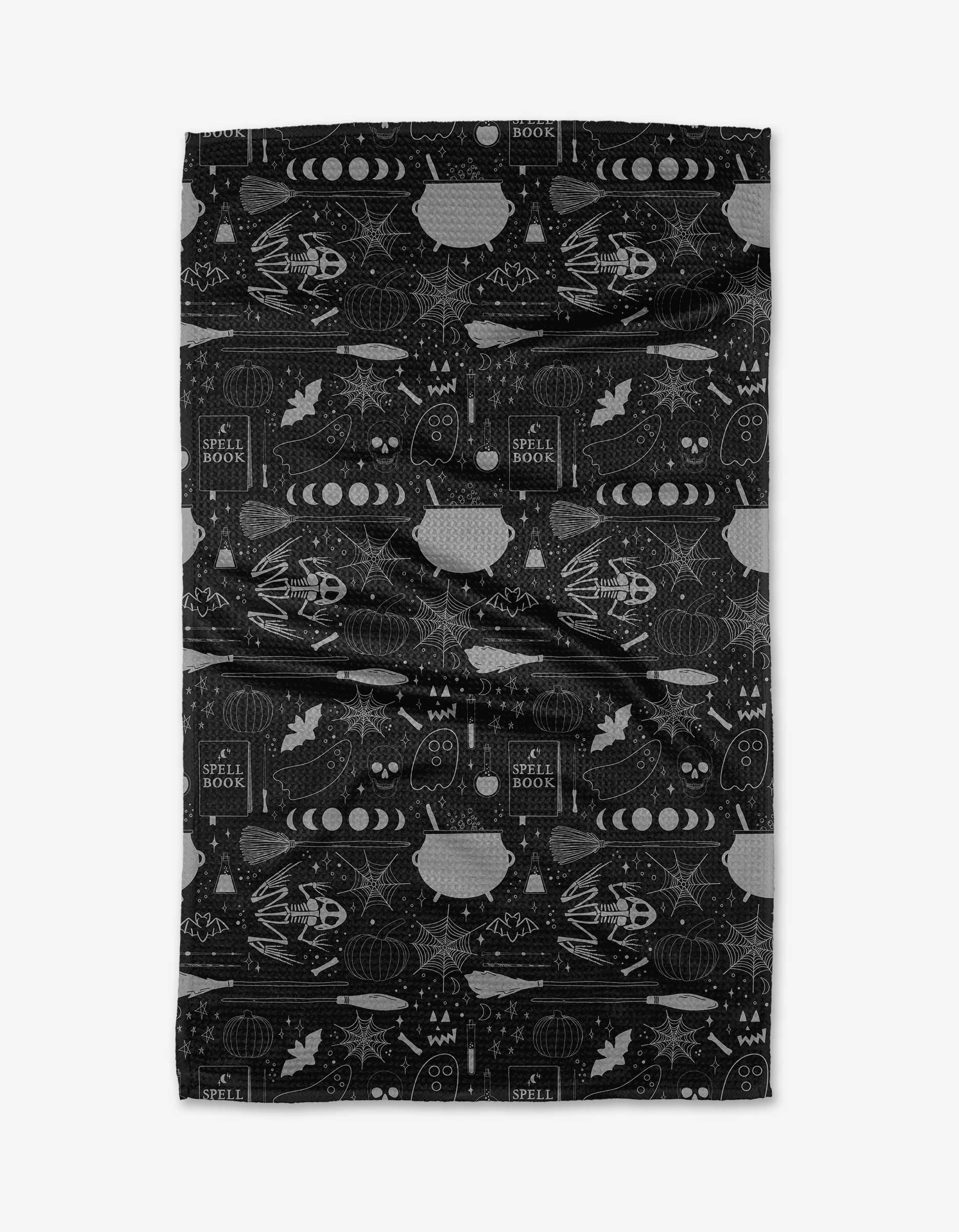 The Rosa Kichline Witches Brew blanket features a black base with repeating Halloween motifs—ghosts, spell books, cauldrons, bats, and pumpkins—crafted from recycled materials for a cozy, eco-friendly touch.