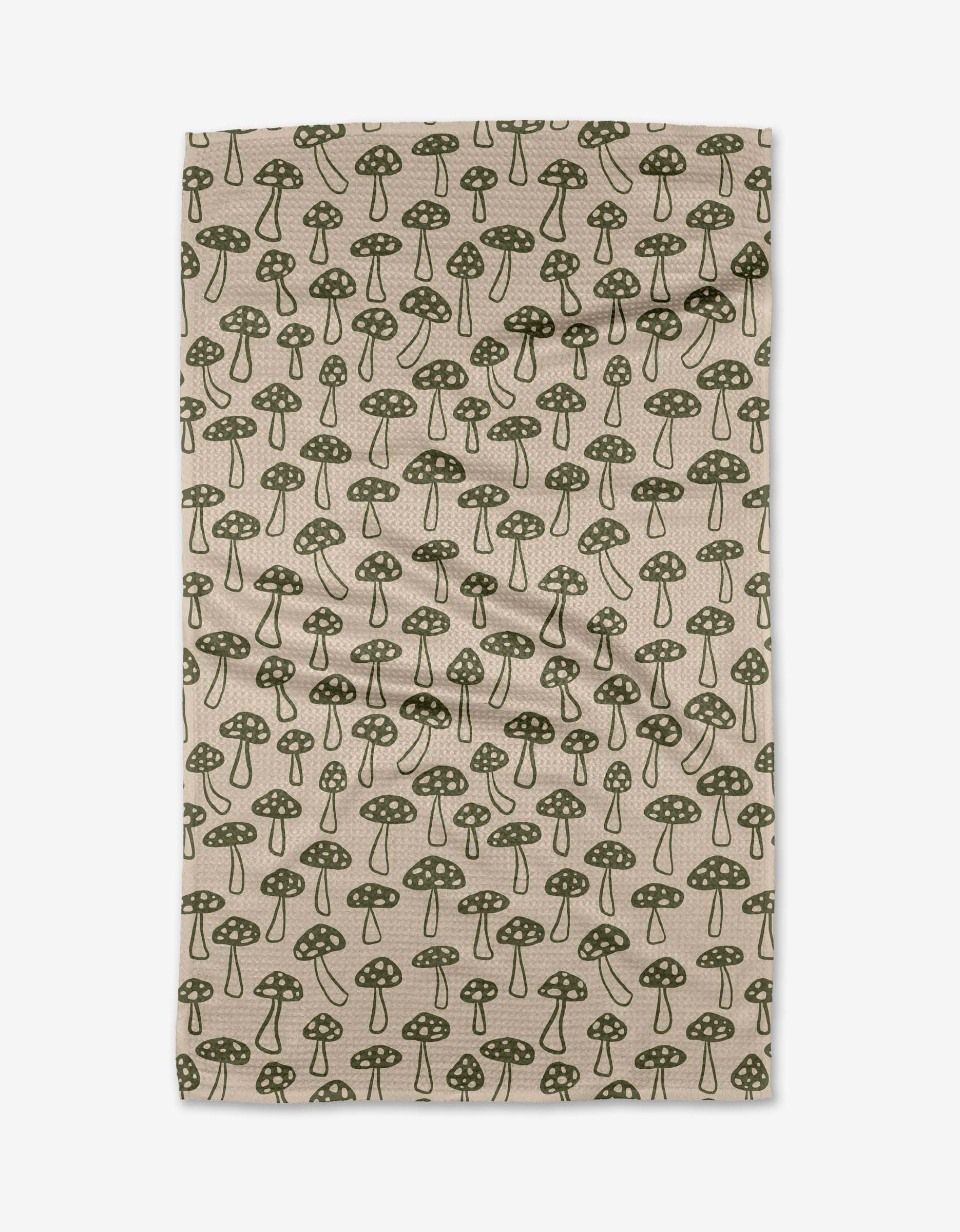The Kayla Ann Woodland Mushroom tea towel, crafted from recycled materials, features a whimsical beige and dark green botanical mushroom print. Ultra-absorbent and perfect for daily kitchen use.