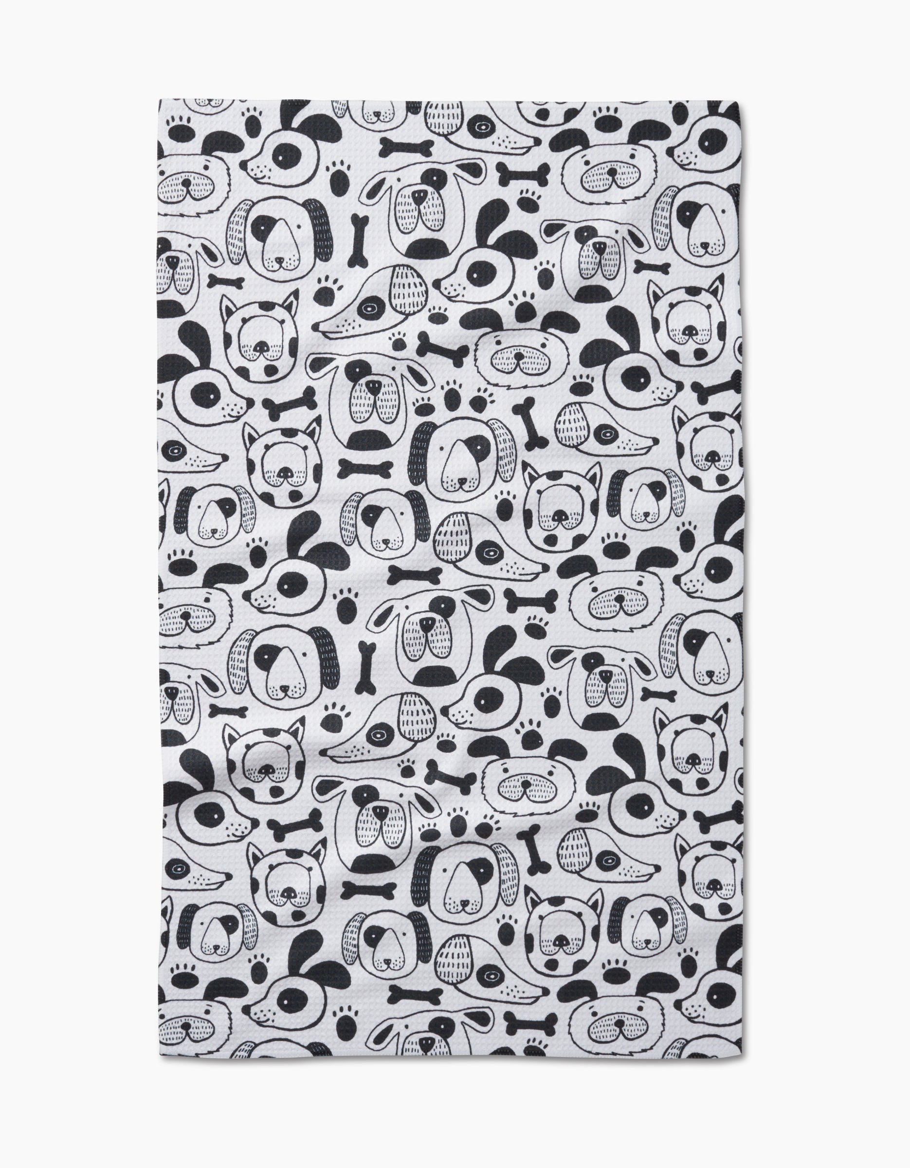 The Woofin Around dish towel by Jessica Swift features ultra-absorbent Geoweave fabric and a white background with black dog faces, bones, and paw prints in a charming repeating pattern.