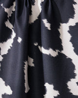 A close-up of Wrangler by Geometry shows black and white fabric with an abstract, irregular pattern. Made from recycled materials, the fabric is slightly gathered at the top, creating soft folds and shadows.